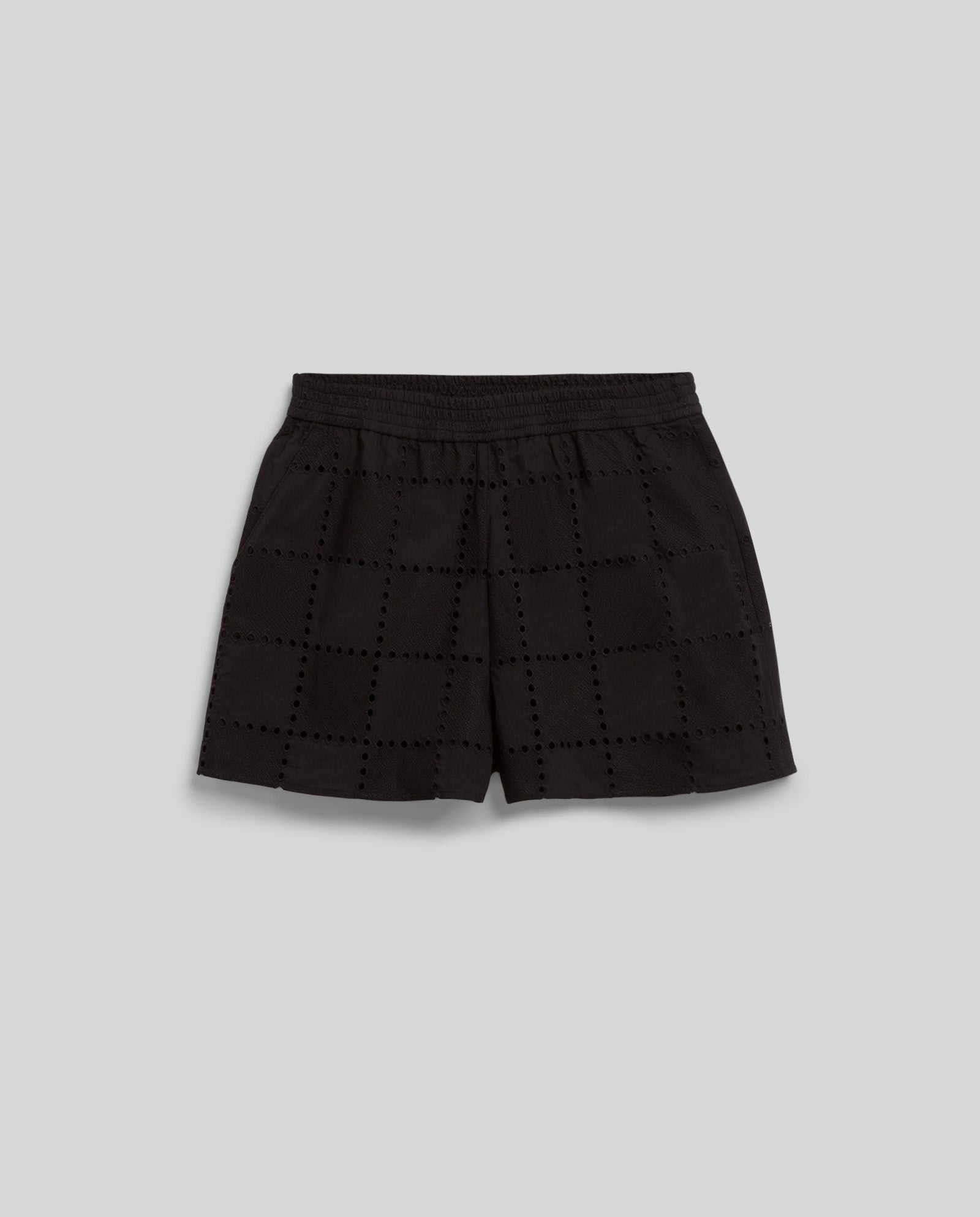 IVY OAK PIPER SUE Trousers in black feature an elastic waistband and a square eyelet pattern in broderie anglaise, shown against a plain grey background.