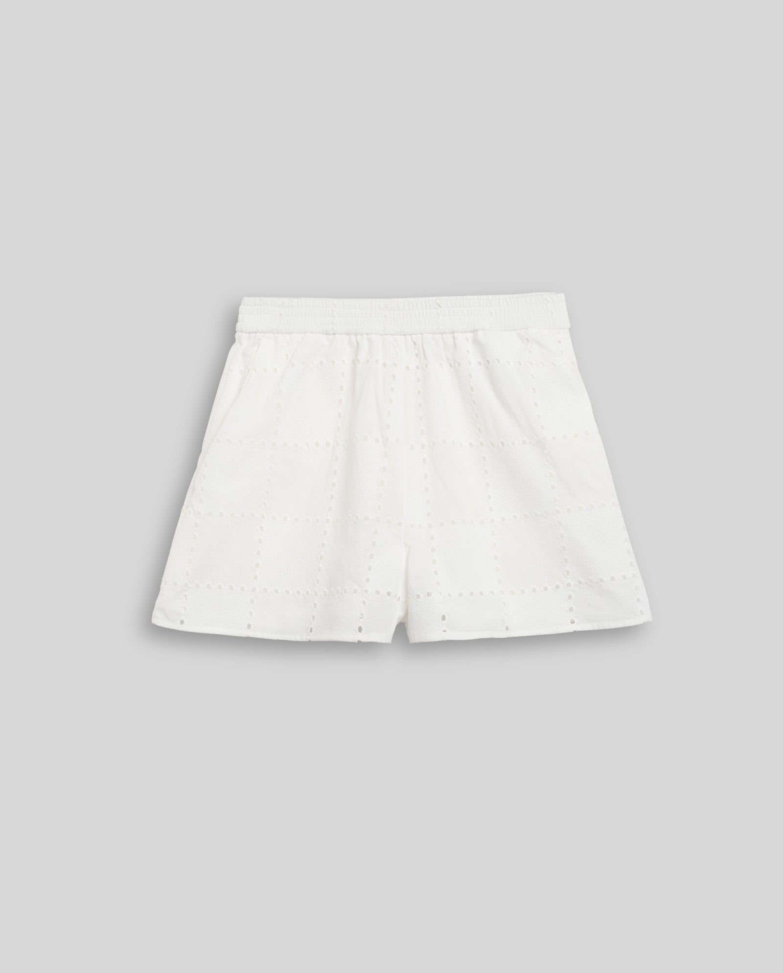 The IVY OAK PIPER SUE Trousers are white broderie anglaise shorts with an elastic waistband, shown against a light gray background.