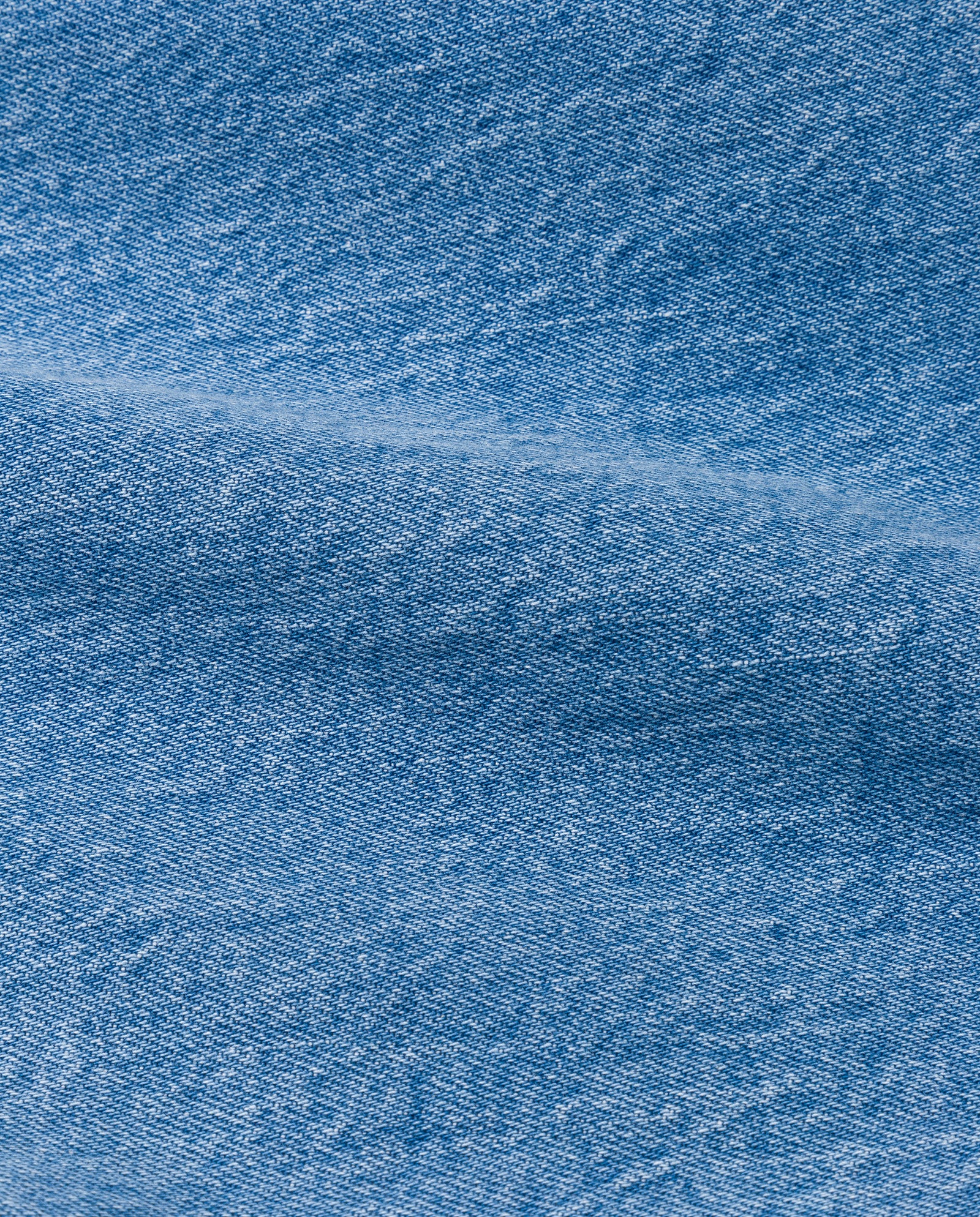 Close-up of blue denim fabric with visible seam and textured weave, perfect for IVY OAKs PHILA Pants—stylish womens long trousers with a deconstructed denim design.