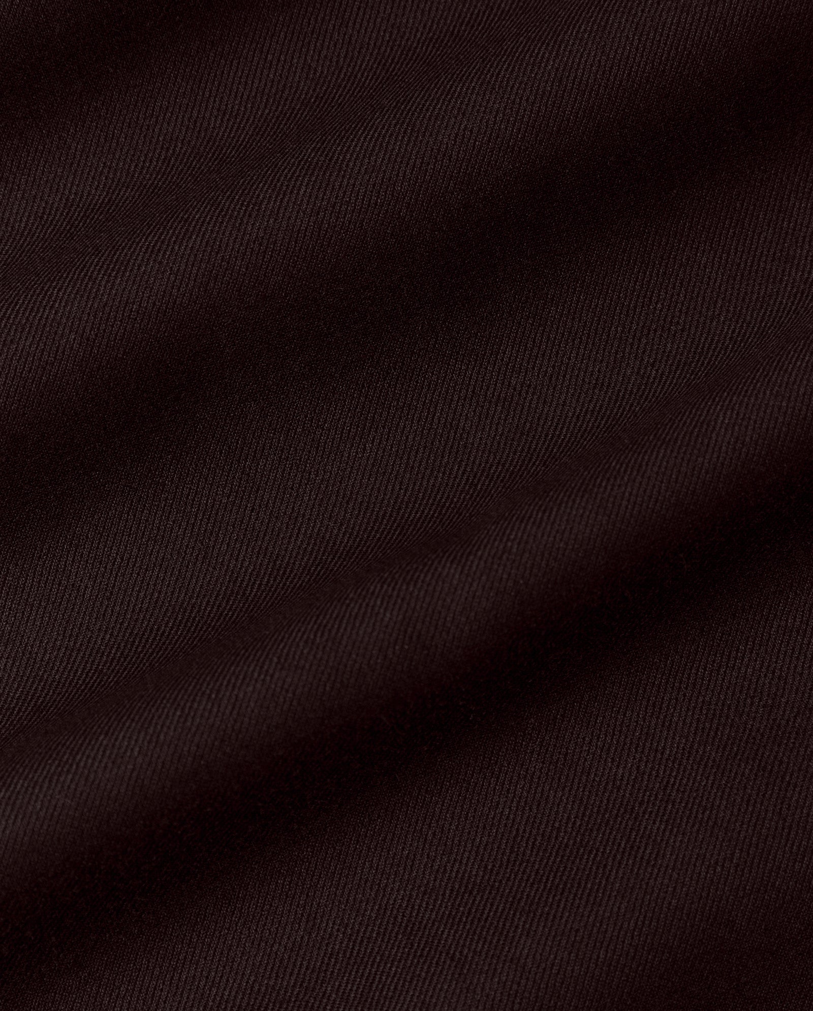 Close-up of dark brown, diagonally ribbed fabric with soft folds and subtle texture—ideal for the IVY OAK SUSANNA Skirt, perfect for pleats or a maxi length style with pockets.