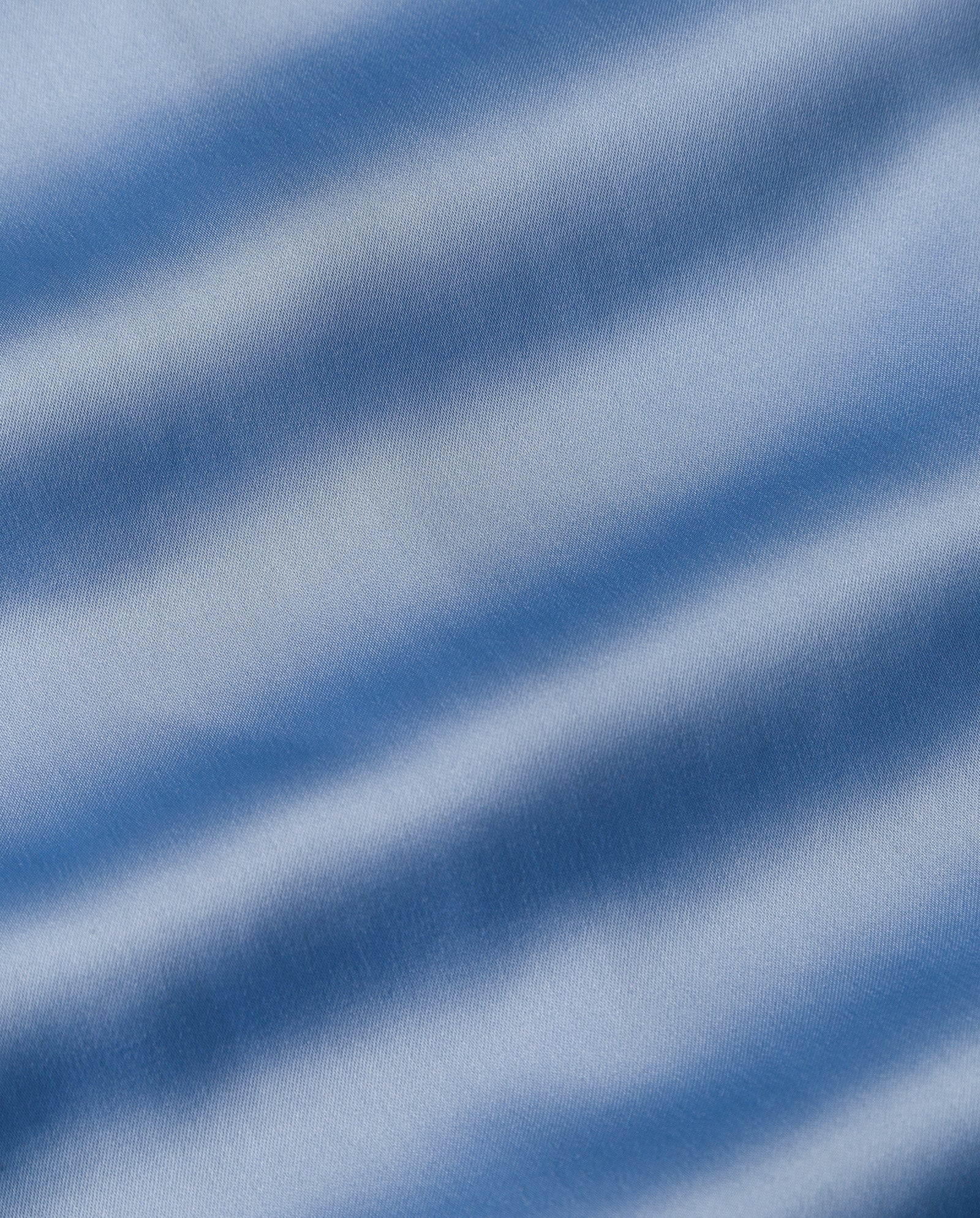 Close-up of light blue NAIA acetate fabric with gentle waves and subtle shading, as seen on the ankle-length SANNA Skirt by IVY OAK.