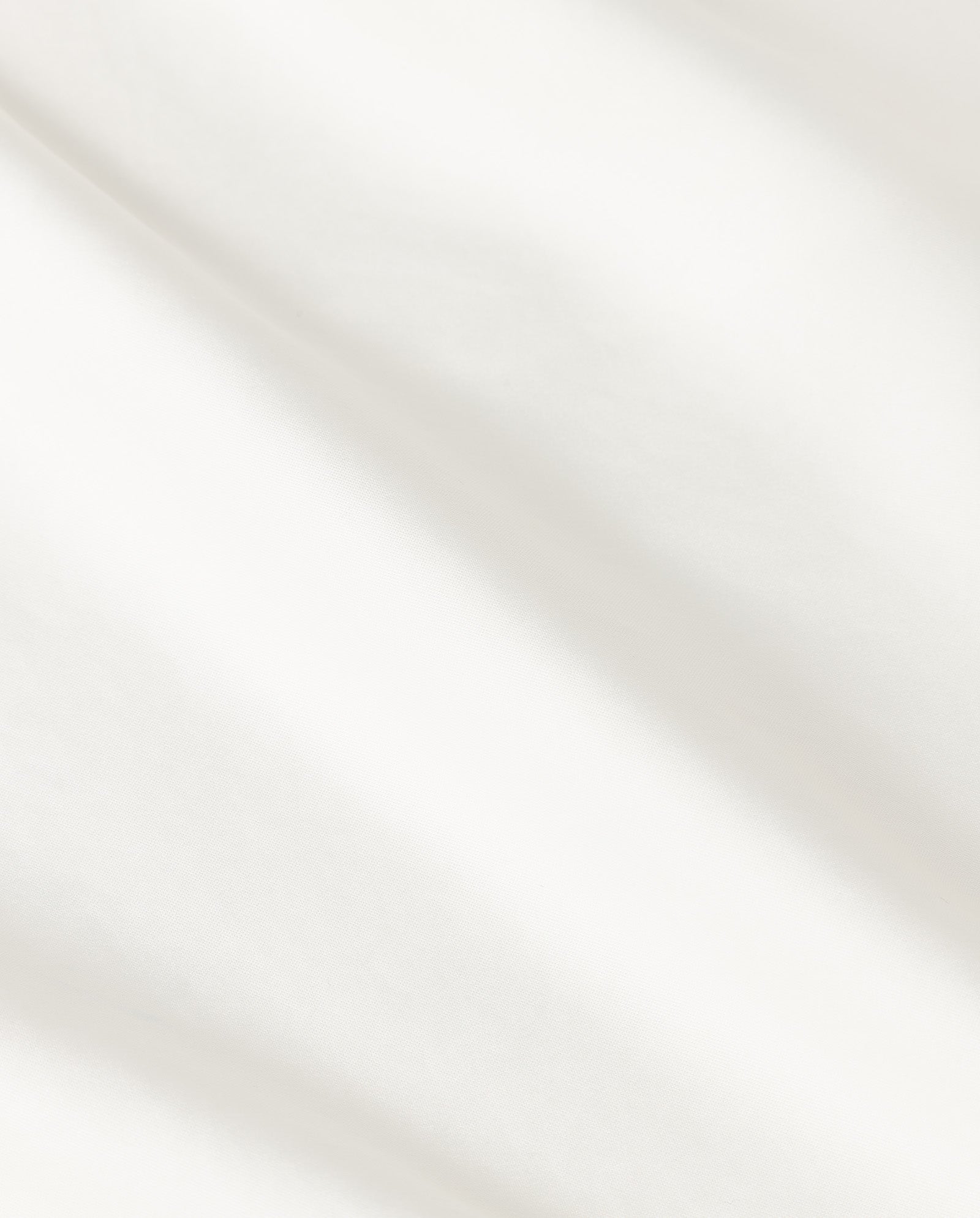 The SANNA Skirt by IVY OAK features smooth white NAIA acetate fabric with soft, gentle folds and a subtle sheen.