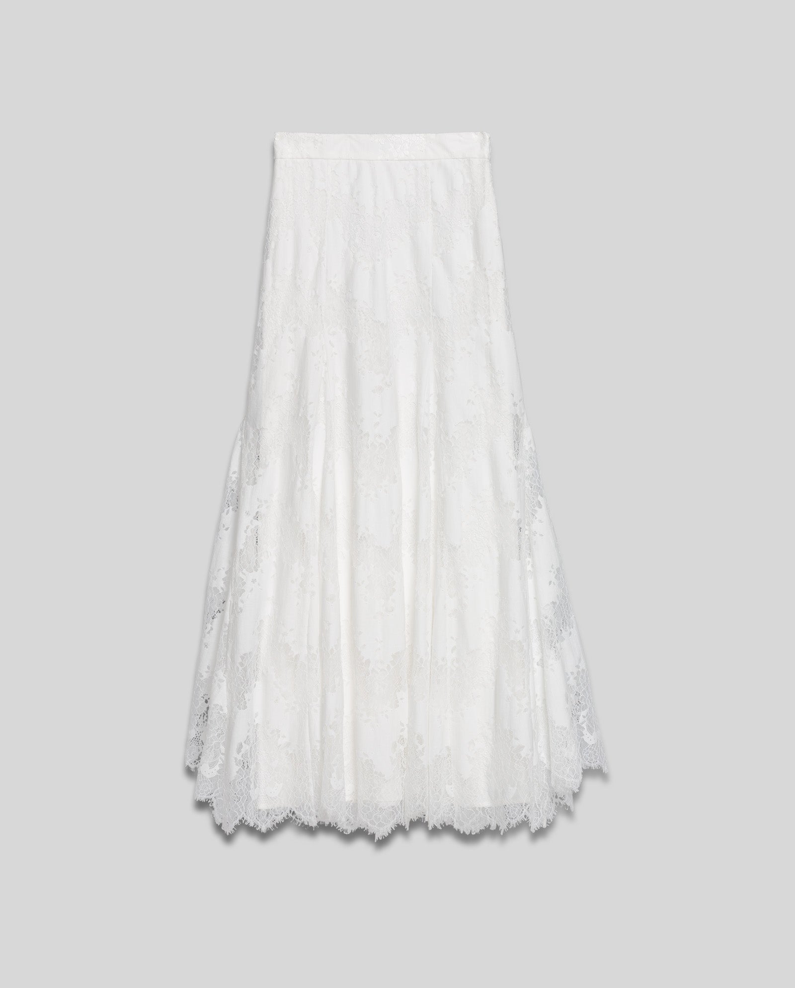 The SHAYA Lace Skirt by IVY OAK is a white lace midi with a flared hem and concealed zipper, shown against a plain light gray background.