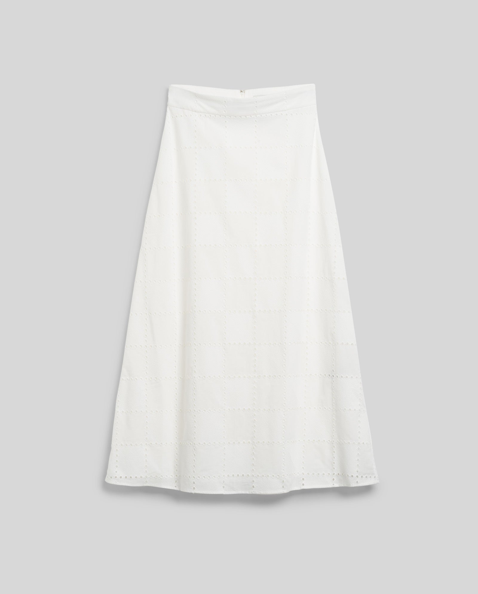 The SAMANTHA Skirt by IVY OAK is a white A-line midi skirt featuring a subtle square eyelet pattern and back zipper closure, shown on a plain light grey background.
