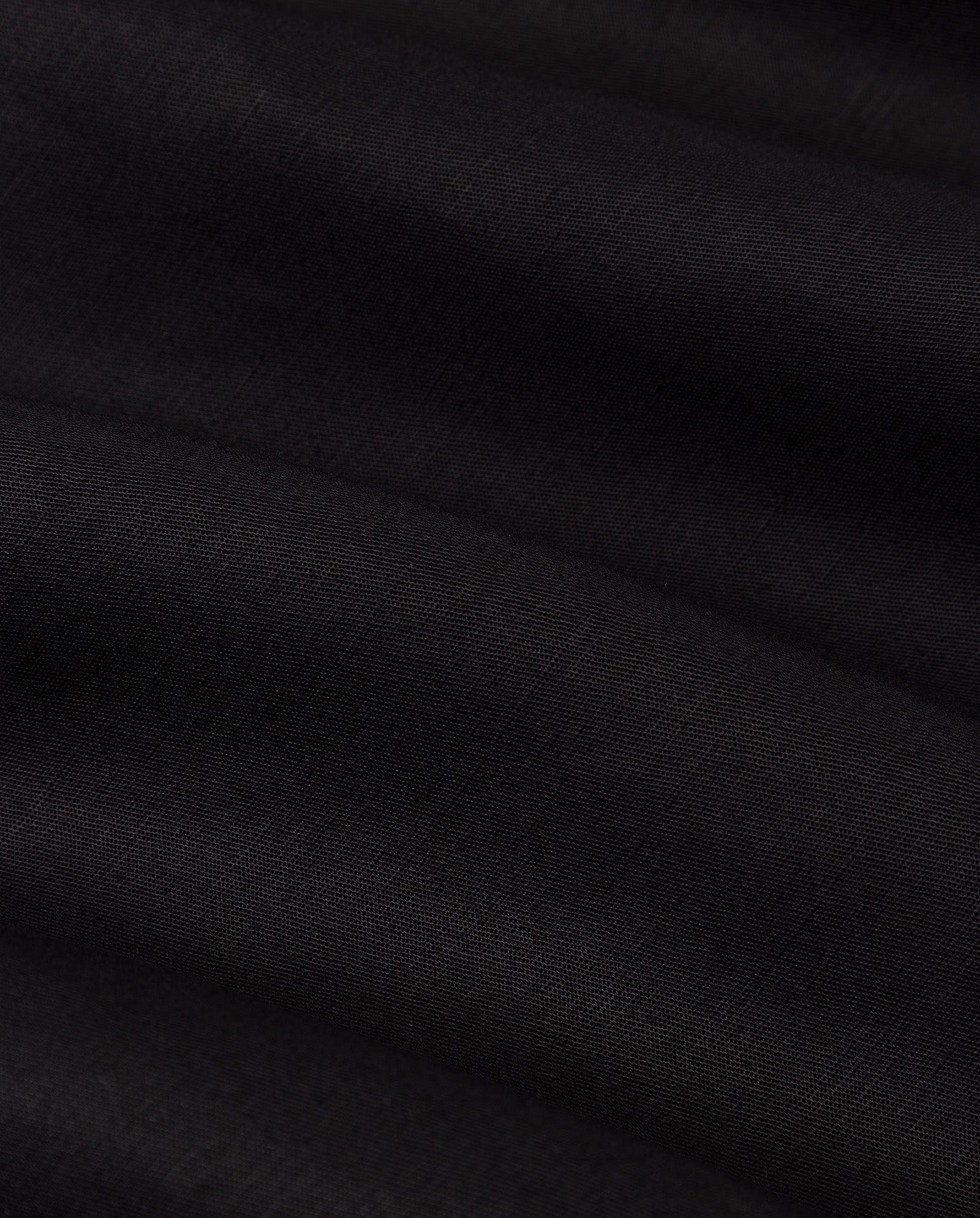 Close-up of smooth, dark black linen blend fabric with soft folds and subtle texture—ideal for the IVY OAK SAMANTHA ANN Skirt.
