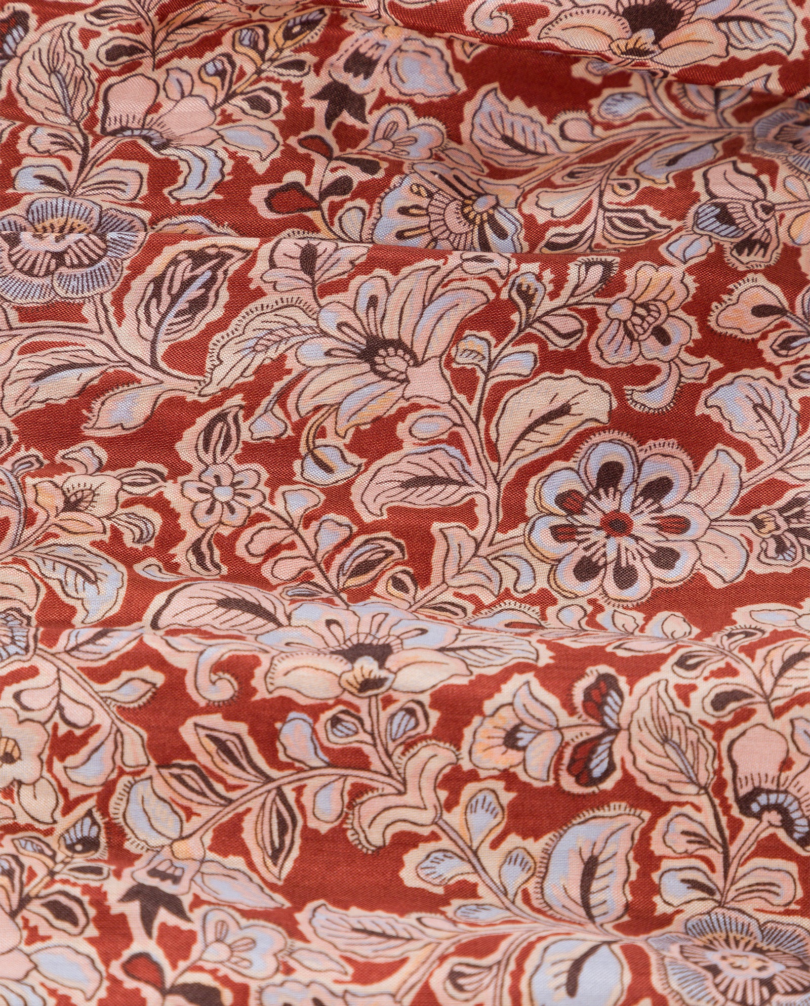 The DREA Dress by IVY OAK features red fabric with intricate floral patterns in cream, blue, and black, showcasing large flowers and leaves in a gorgeous maxi length design.