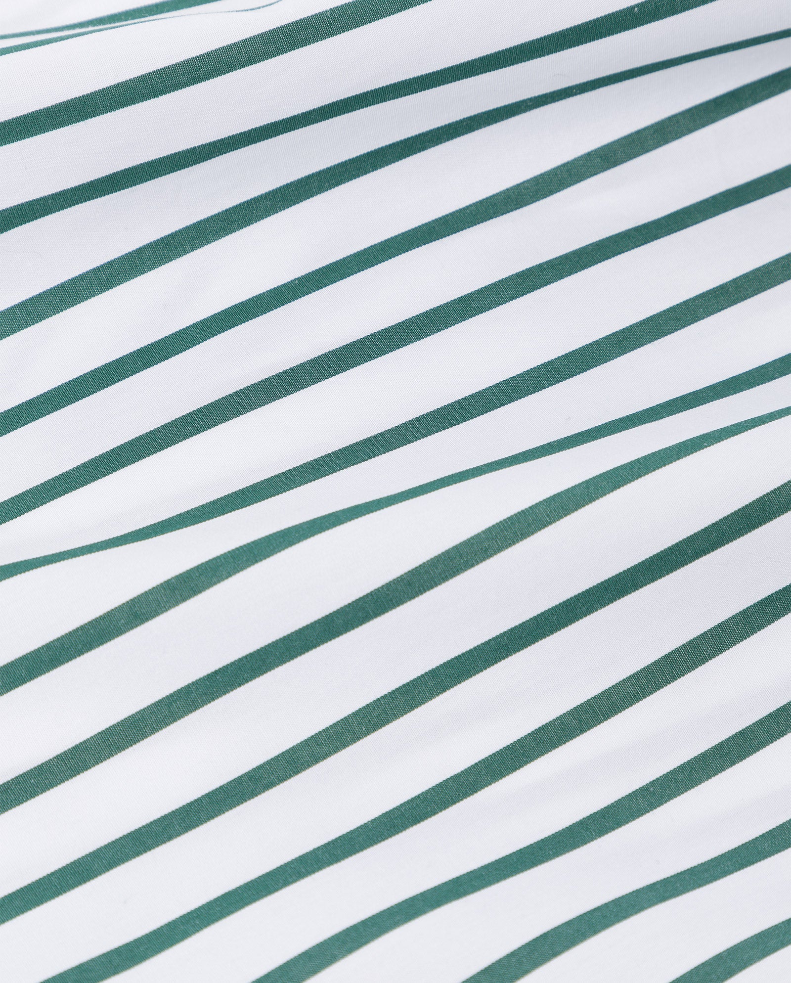 White fabric with diagonal green stripes, made from soft organic cotton, forms a clean geometric pattern—ideal for the DINA KIM Dress by IVY OAK.