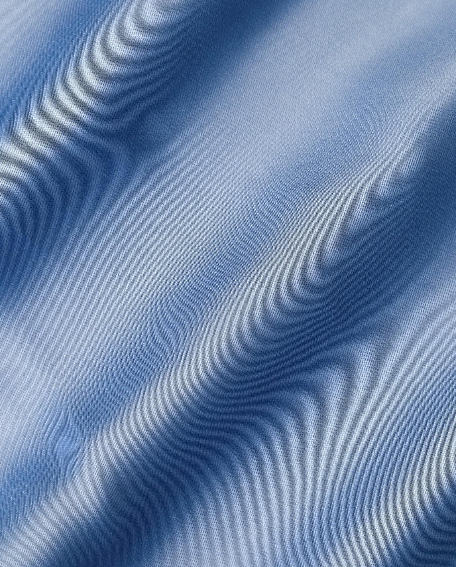 The MARCELLA LIZ Dress by IVY OAK features smooth light blue fabric with soft diagonal folds and shadows, creating a gentle wavy texture—ideal for its maxi silhouette and elegant stand-up collar.