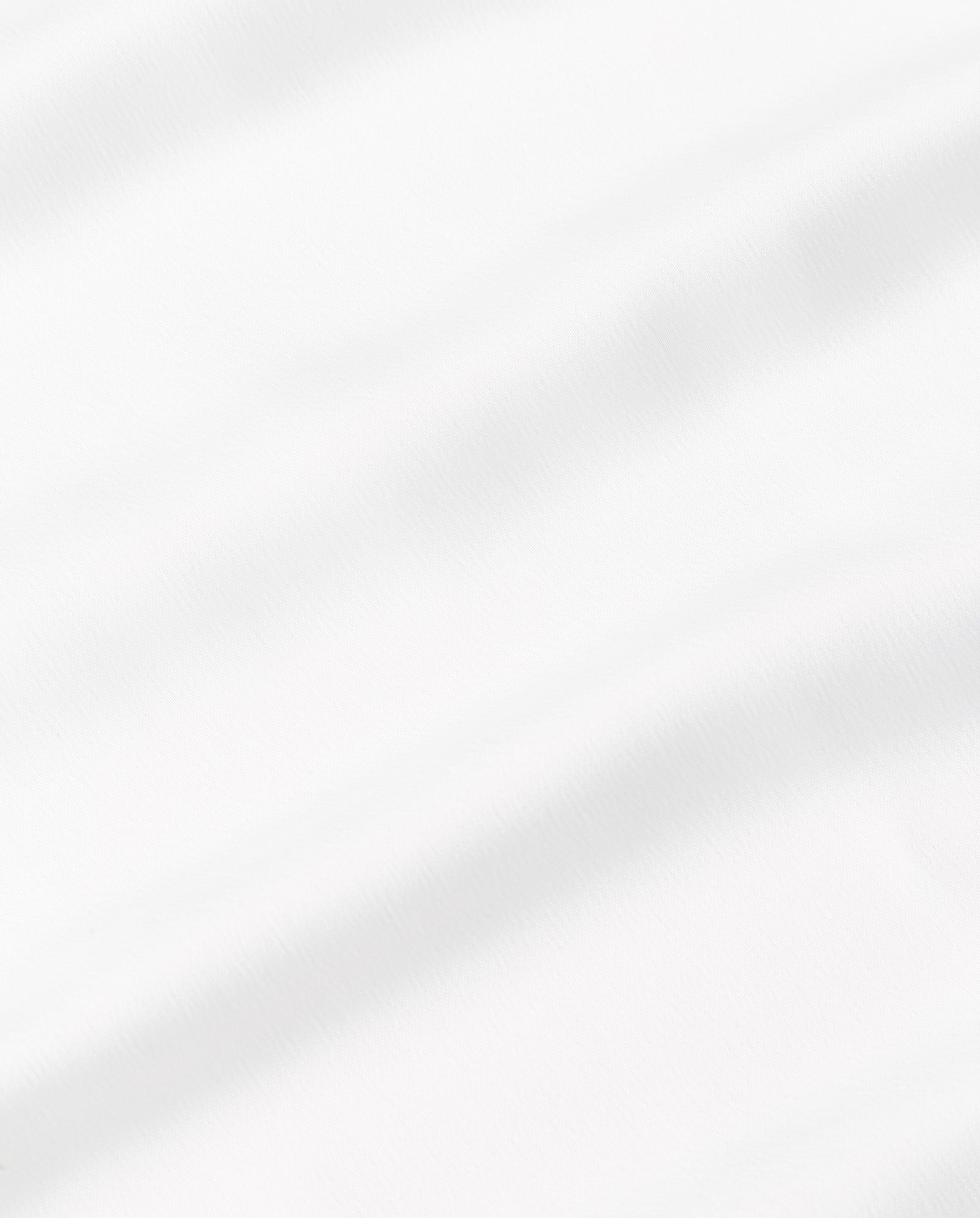 White fabric with soft, diagonal folds creates gentle shadows and a smooth texture, evoking the elegance of the IVY OAK MARCELLA LIZ Dress.