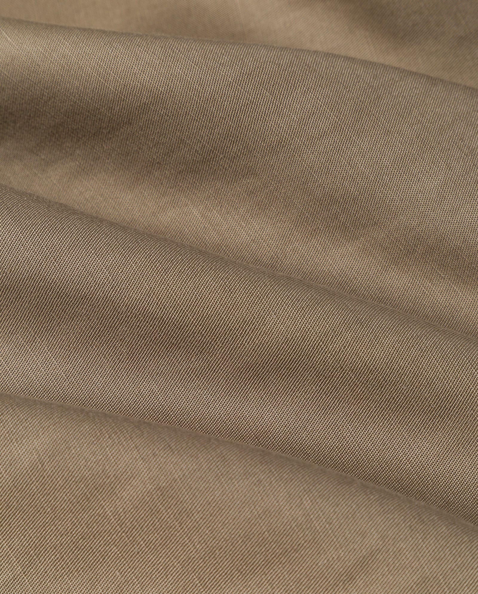 Close-up of the NELA Dress by IVY OAK, featuring light brown, ribbed linen-blend fabric with soft folds and a slightly textured surface.