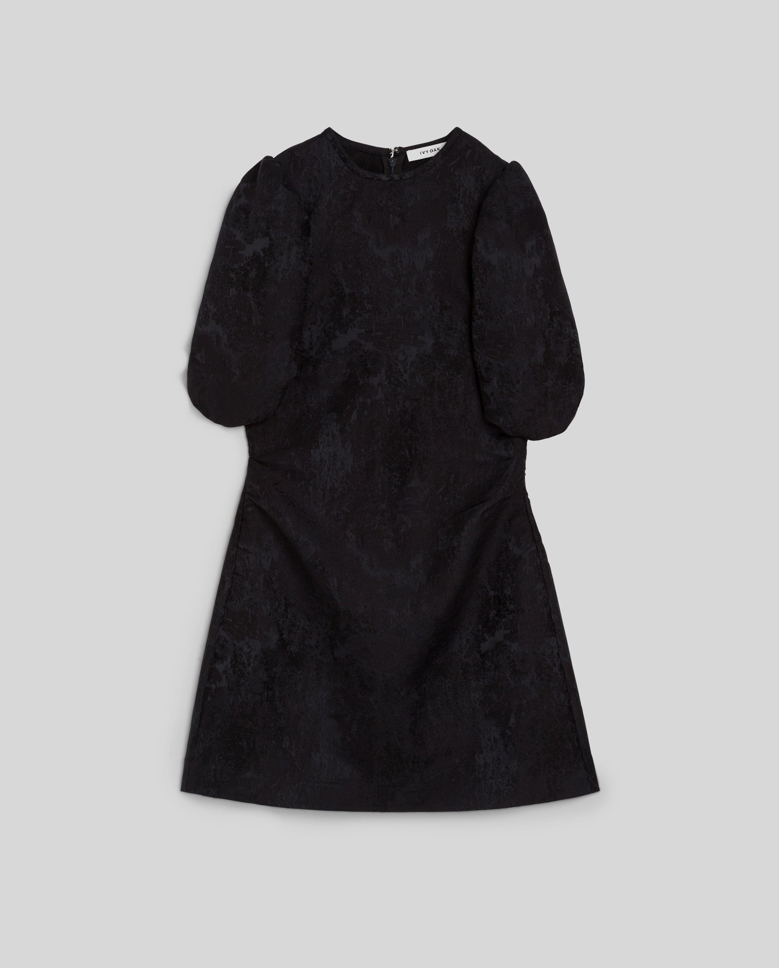 IVY OAK NISSA jacquard mini dress with short puff sleeves, textured fabric, and a back zipper, shown laid flat on a gray background.