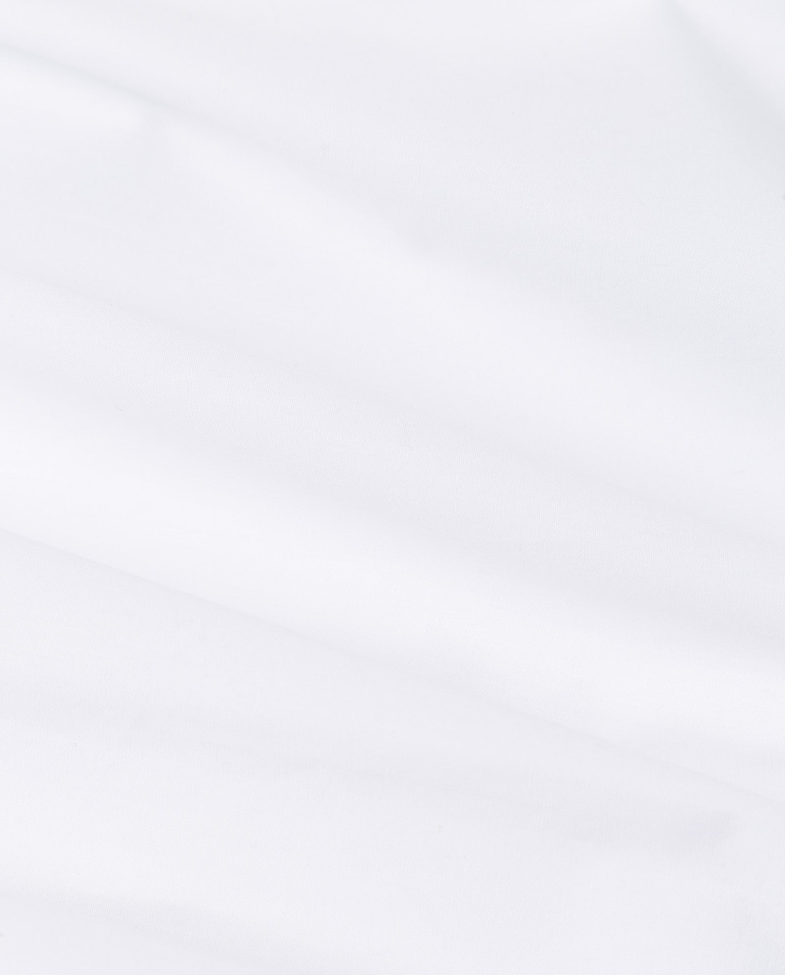 The DINA ROSA Dress by IVY OAK features white fabric with soft folds and subtle shadows, offering a smooth, minimalist texture inspired by the timeless look of a classic shirt.