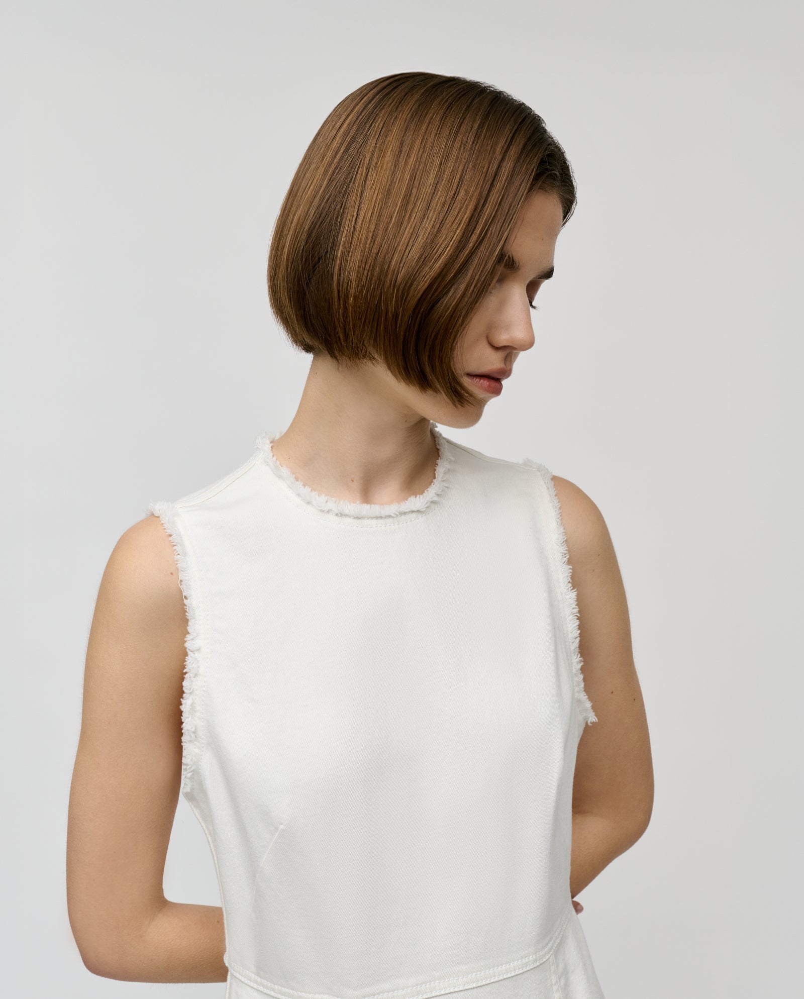 A woman with straight, chin-length brown hair looks down, modeling the IVY OAK MARCA ANN Denim Dress against a plain background.