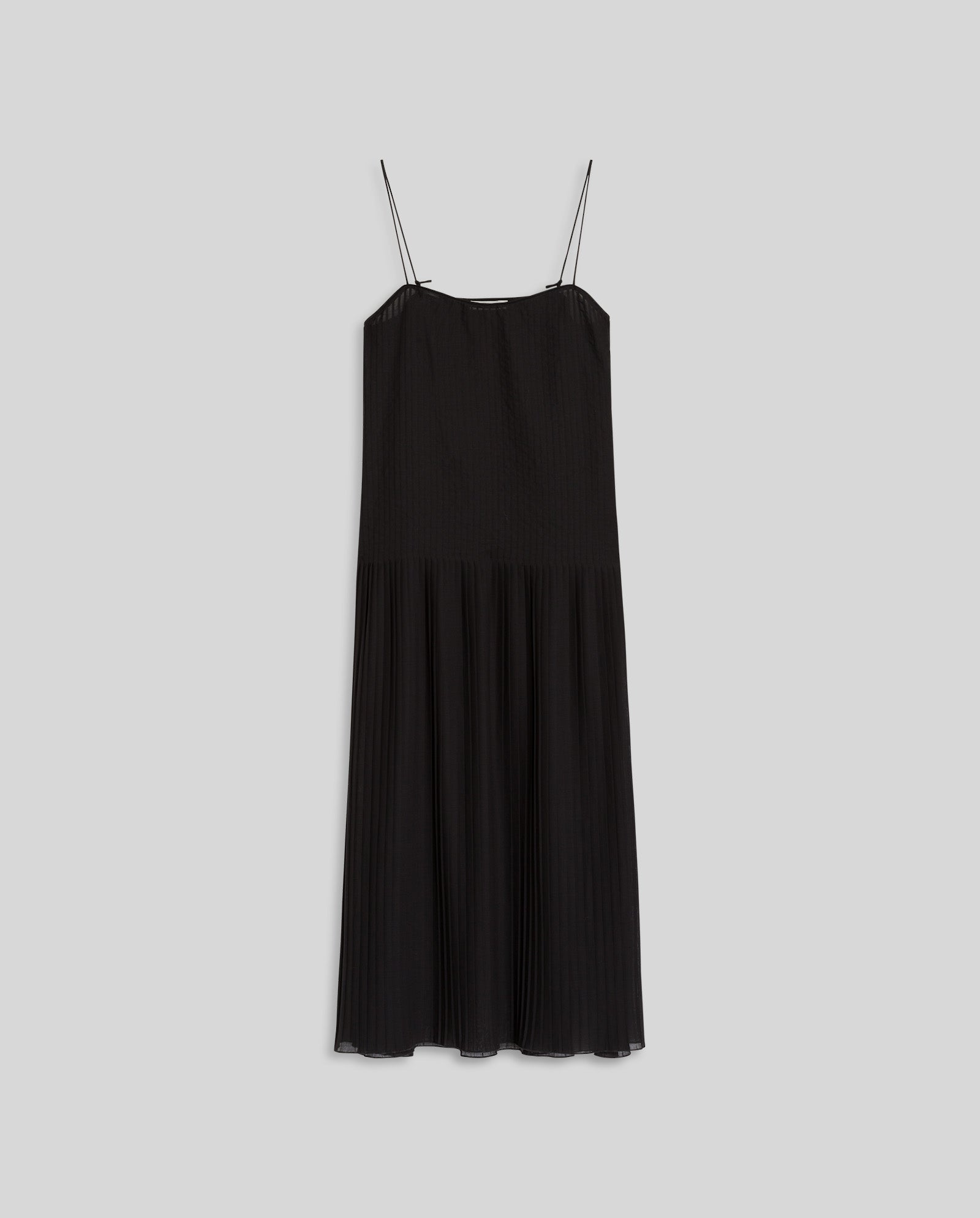 The IVY OAK NOE Dress is a black plissé fabric midi summer dress with thin spaghetti straps, shown on a plain light gray background.