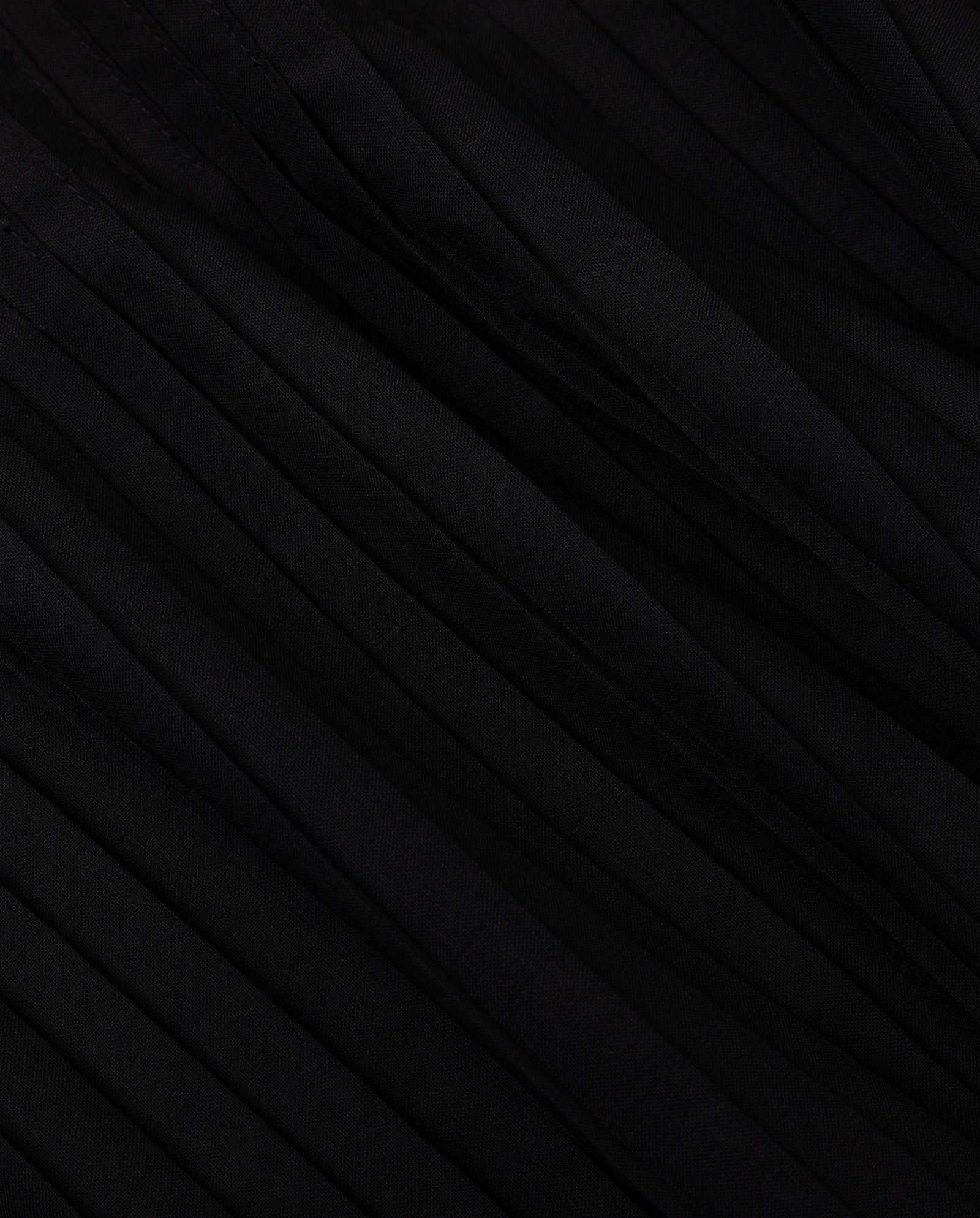 Close-up of black plissé fabric with diagonal folds and textured lines from the NOE Dress by IVY OAK, perfect for a chic strap dress.