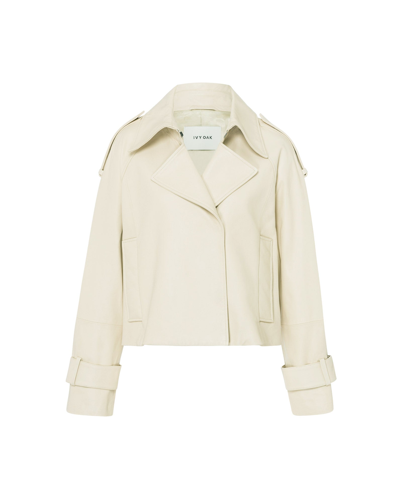 The IVY OAK LILITH ANN Jacket is a cream-colored, cropped style featuring wide lapels, buttoned shoulders, and cuffed sleeves that fuse classic trench coat details with modern chic.