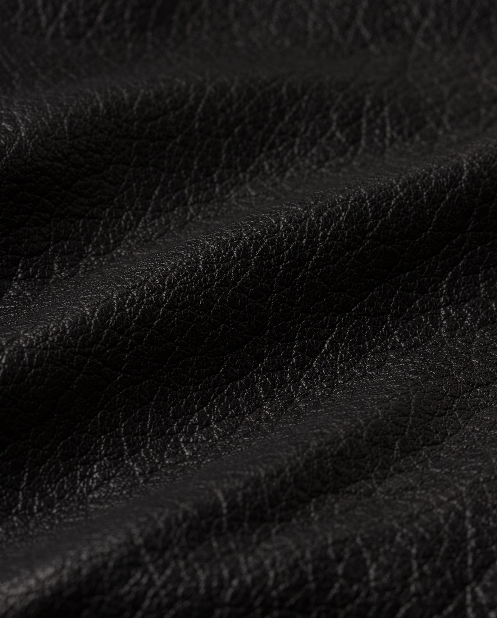 Close-up of the LENNY SUE Jacket by IVY OAK, showcasing textured leather with visible grain and gentle folds, evoking the timeless style of a classic biker jacket.