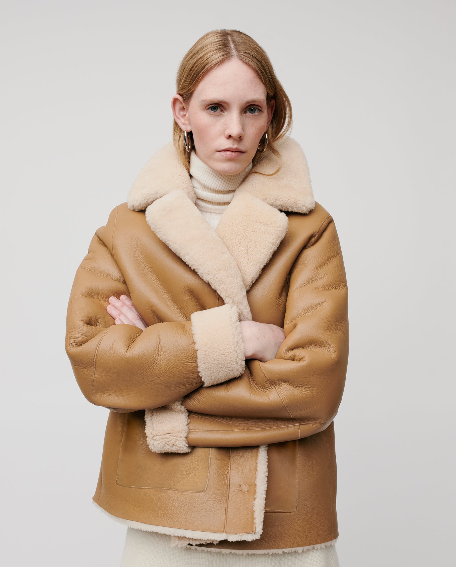 A woman with blonde hair wears the IVY OAK LOTTE Jacket, standing with arms crossed against a plain light background.