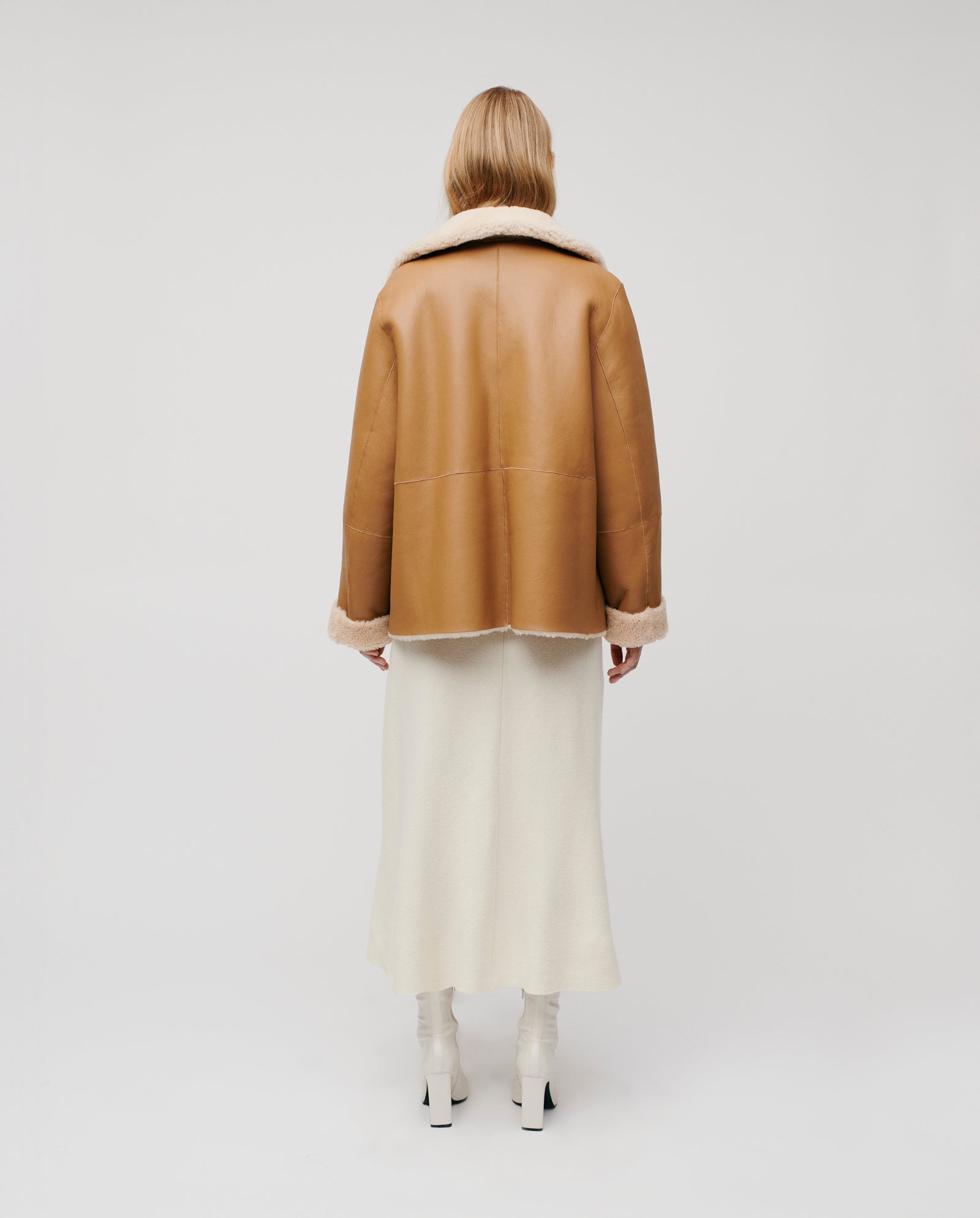 A person in the IVY OAK LOTTE Jacket and a white skirt stands facing away against a plain background.