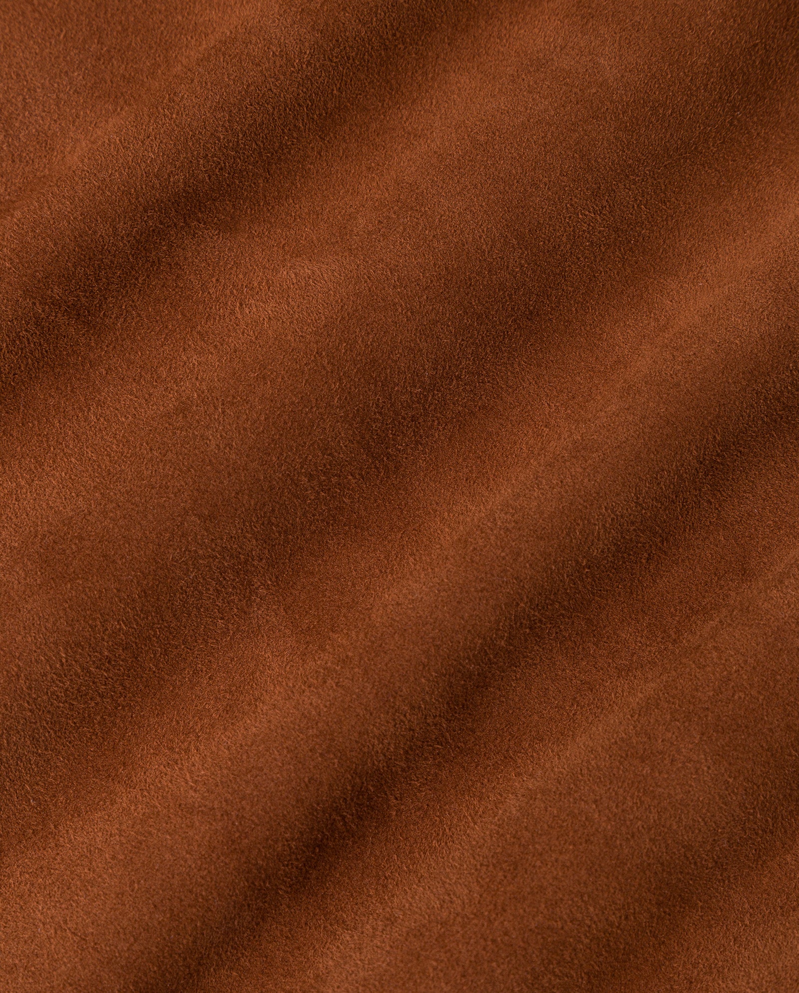 Close-up of the soft brown suede fabric from the IVY OAK LISA Coat, highlighting its gentle diagonal folds and straight-cut design.