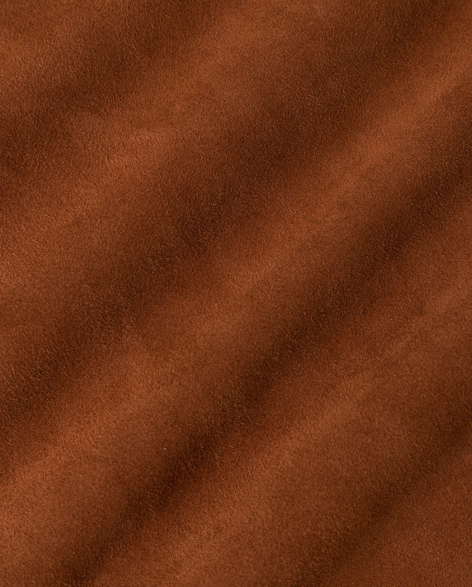 Close-up of soft brown suede fabric, echoing the smooth, textured surface and gentle diagonal folds of the IVY OAK LEA Trousers.