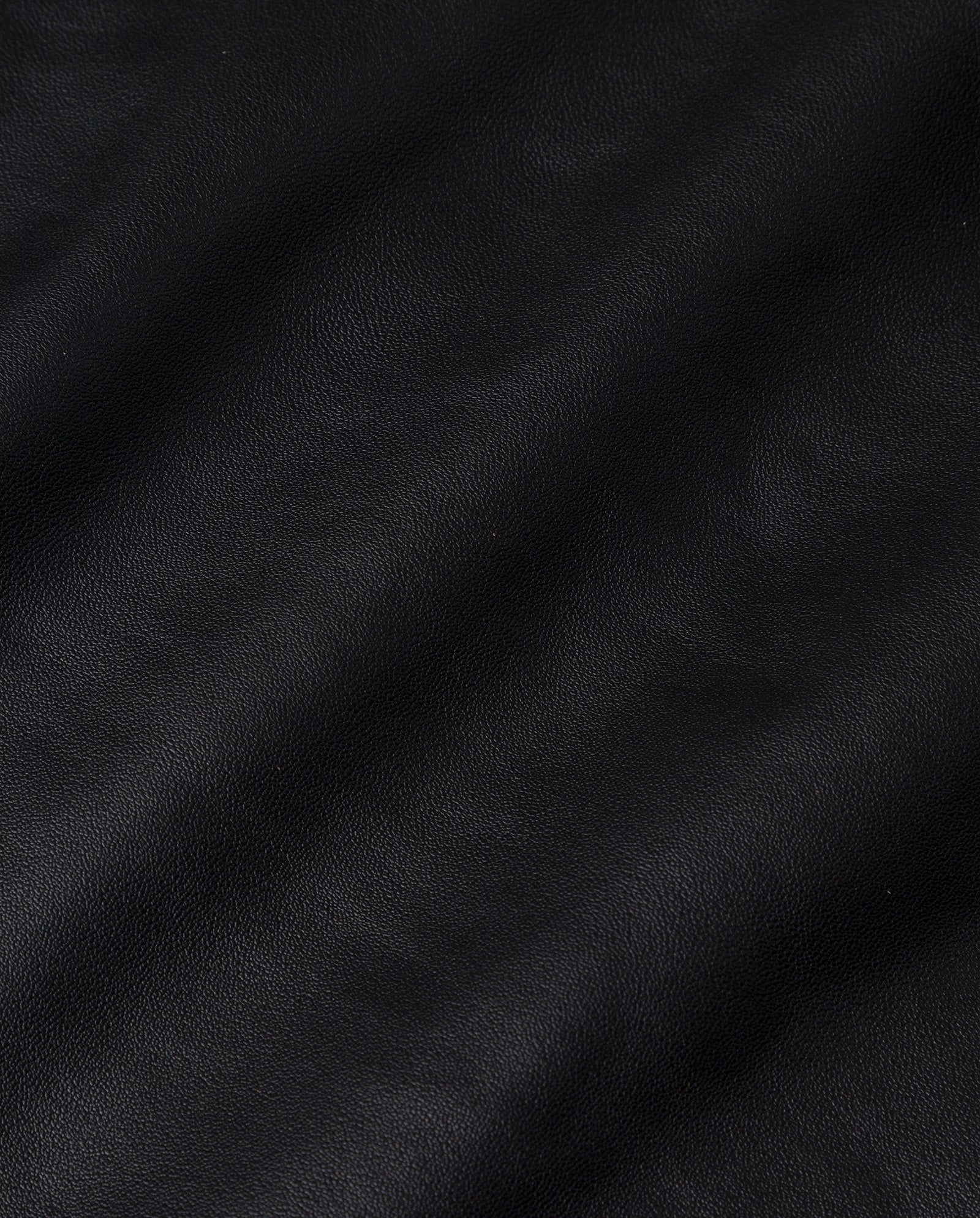 Close-up of the LIANA SUE Skirt by IVY OAK, showcasing black nappa leather with natural wrinkles and grain patterns from chrome-free tanning.