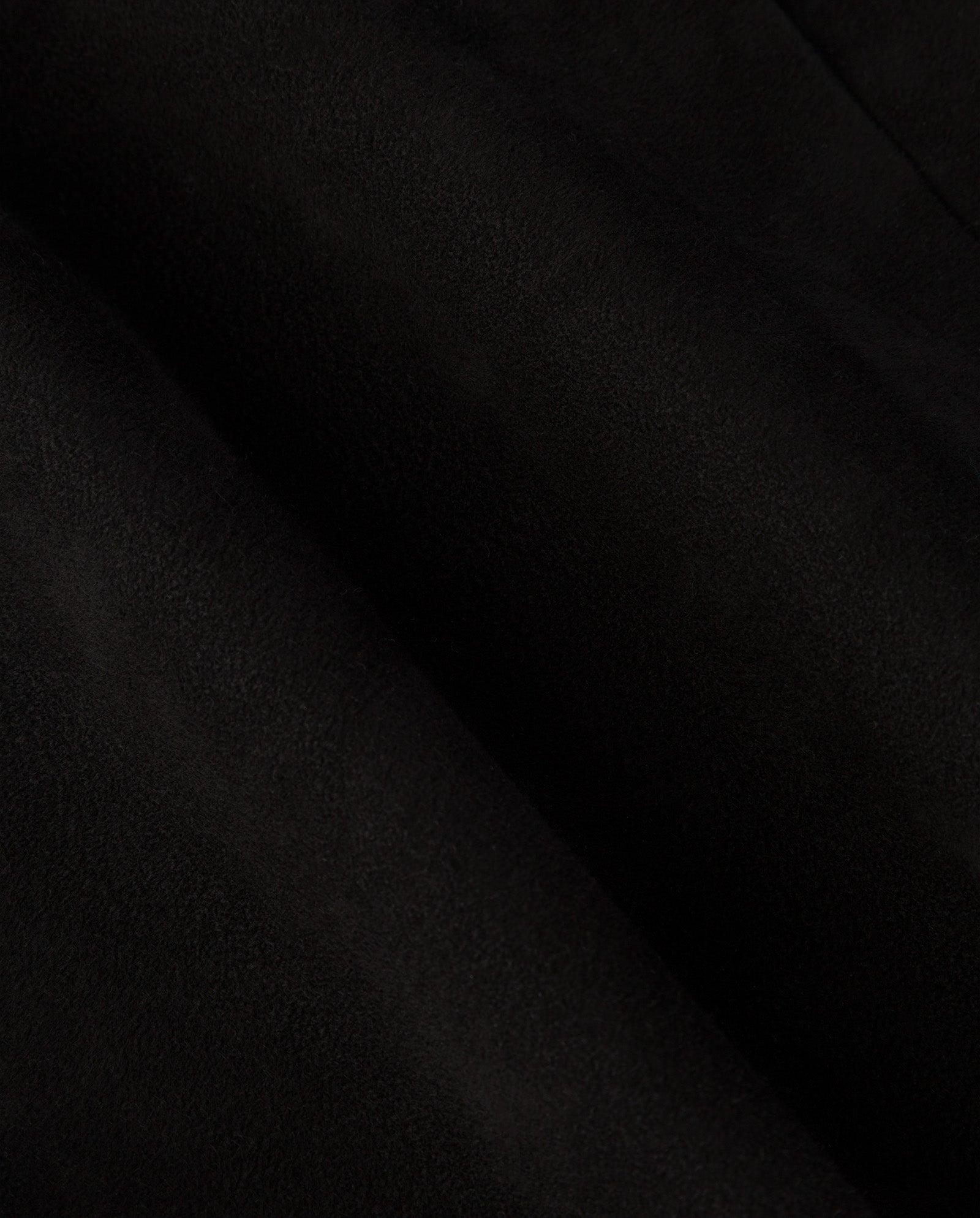 Close-up of the LISANNA ROSE Skirt by IVY OAK, crafted from black suede fabric with a soft, lightly textured surface and gentle folds—ideal for a sophisticated high waist or elegant A-line silhouette.