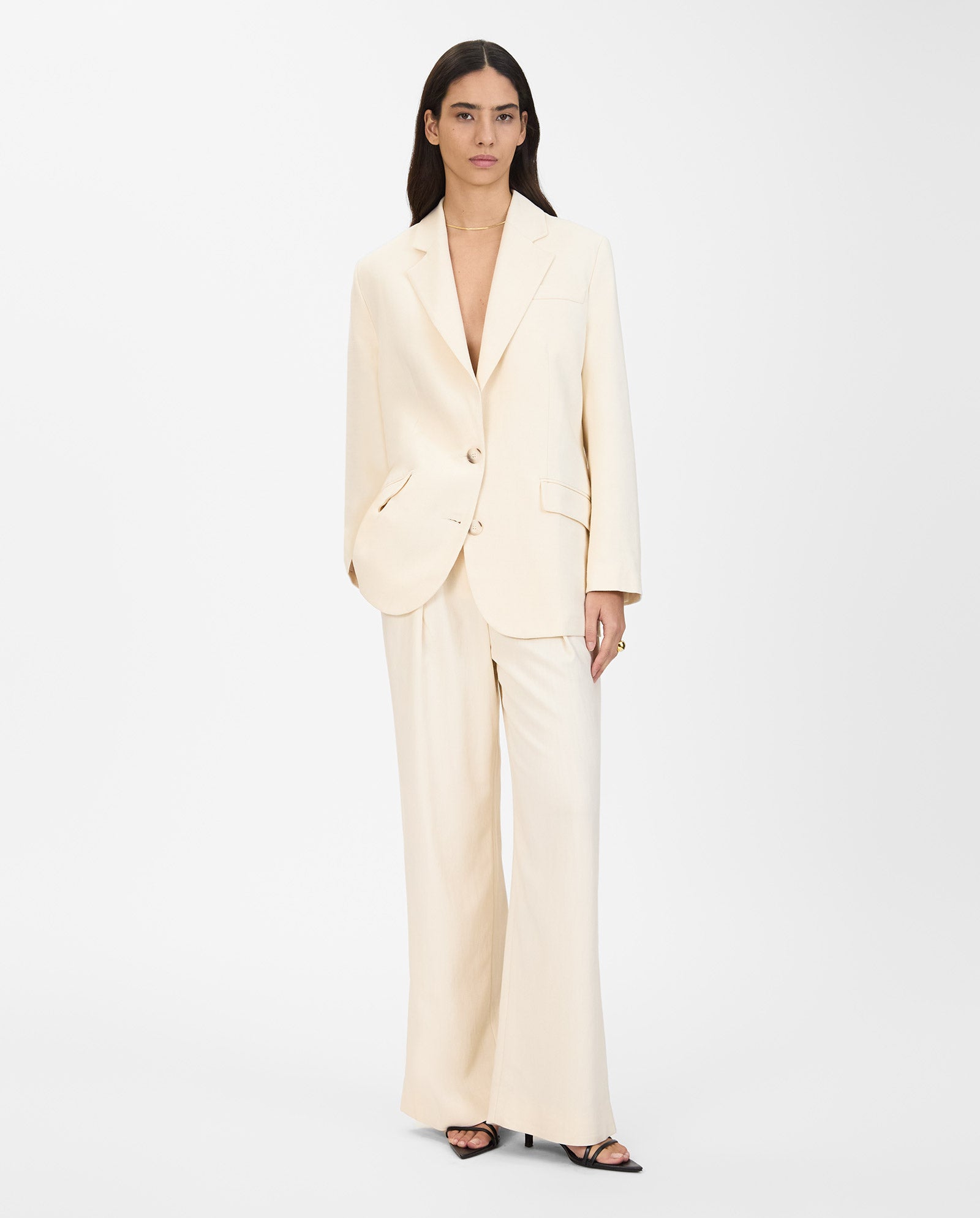 A woman poses against a white background wearing an oversized, single-breasted IVY OAK JUNA Blazer with wide-leg pants and an open jacket.