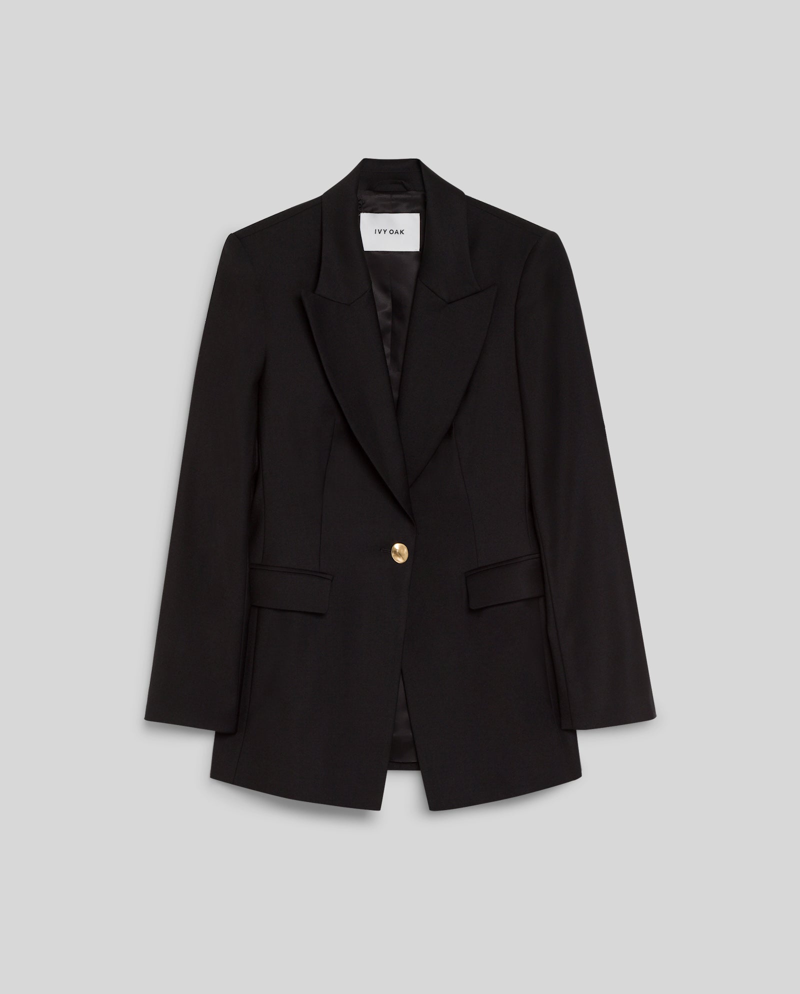 The JOLANKA Blazer by IVY OAK is a black tailored jacket with golden button details, notched lapels, and flap pockets, shown against a gray background.