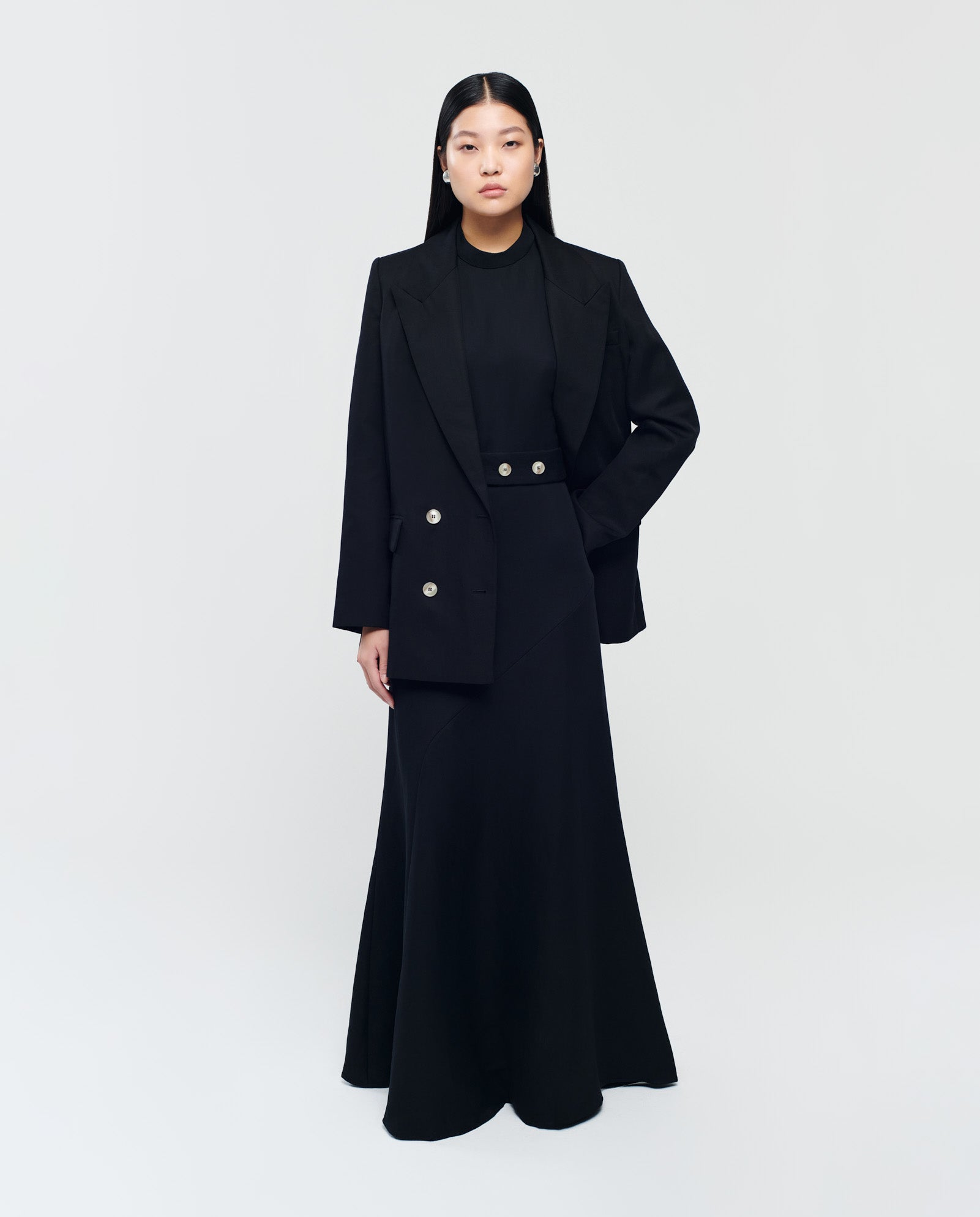 A woman in a long black dress and the IVY OAK JULIETTE MARIE Blazer stands against a plain light gray background.