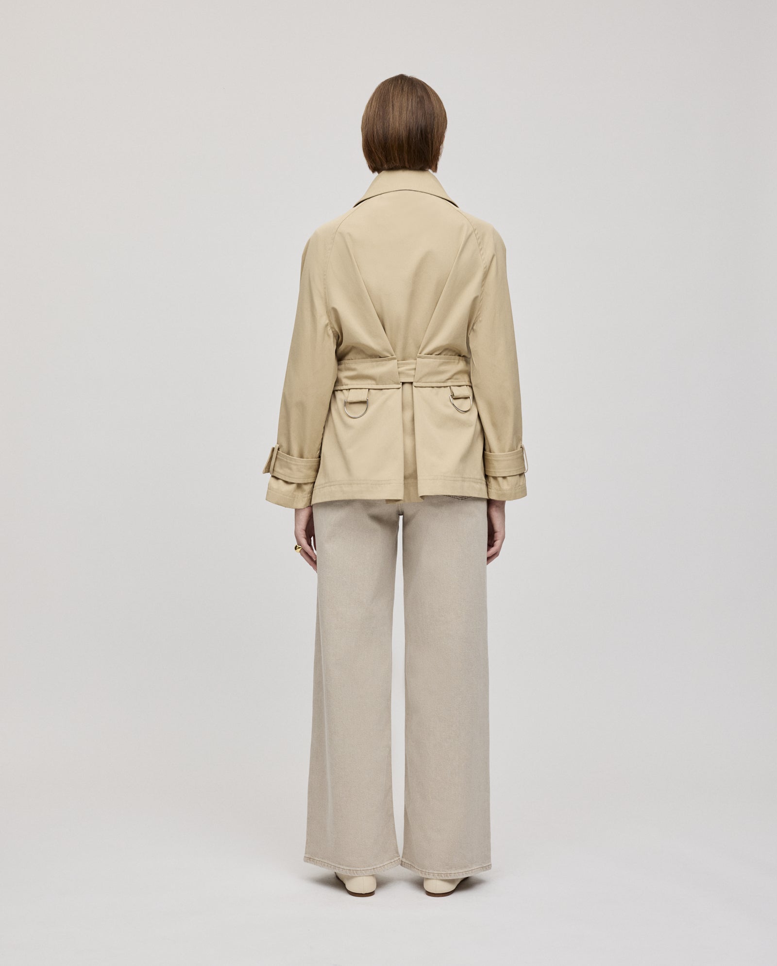 A person faces away, wearing the IVY OAK JULES Jacket with an A-line silhouette and wide-leg pants against a plain light background.