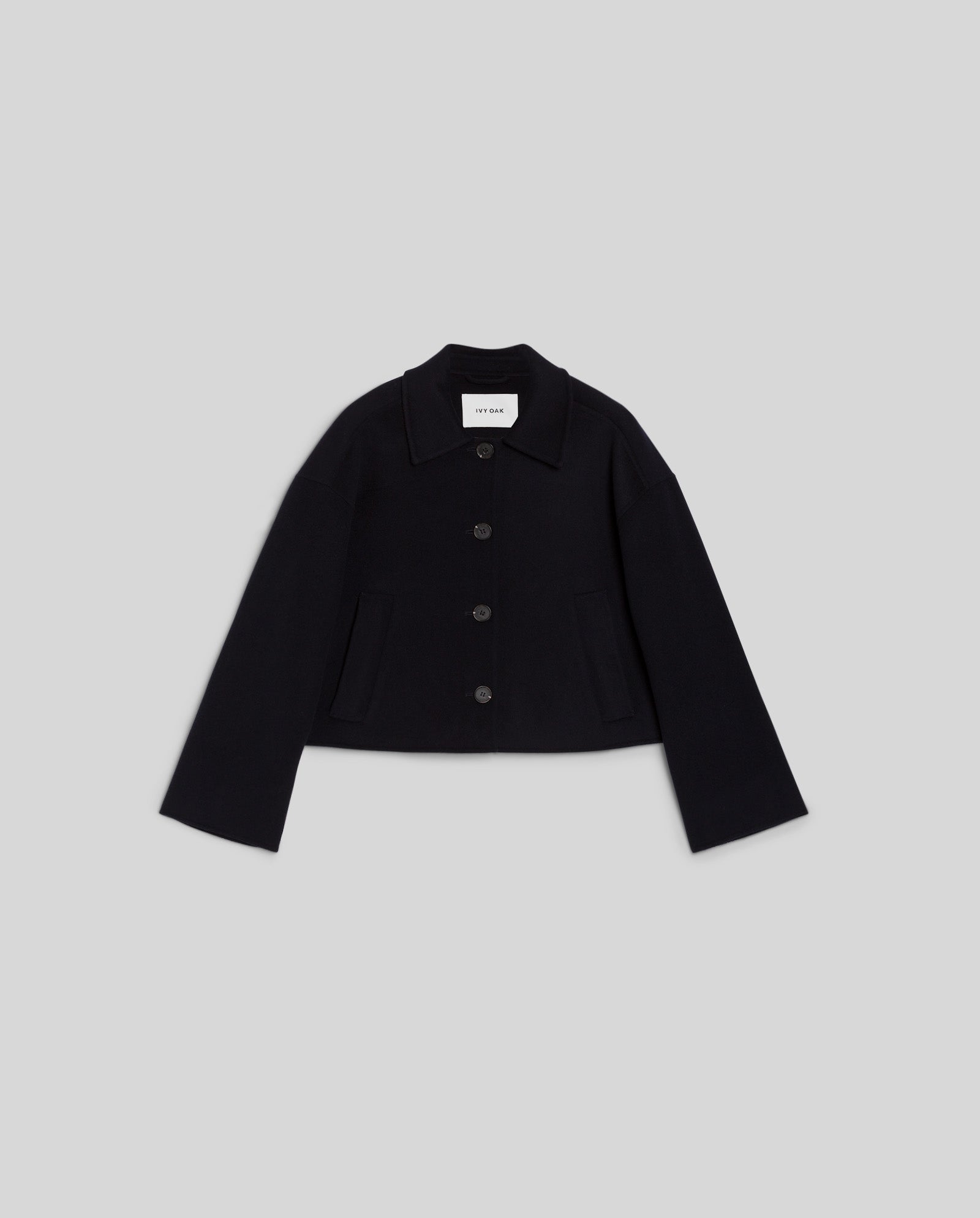 The IVY OAK JAIA Wooljacket, featuring a collar and front pockets in luxurious double-faced fabric, is showcased on a plain light gray background.