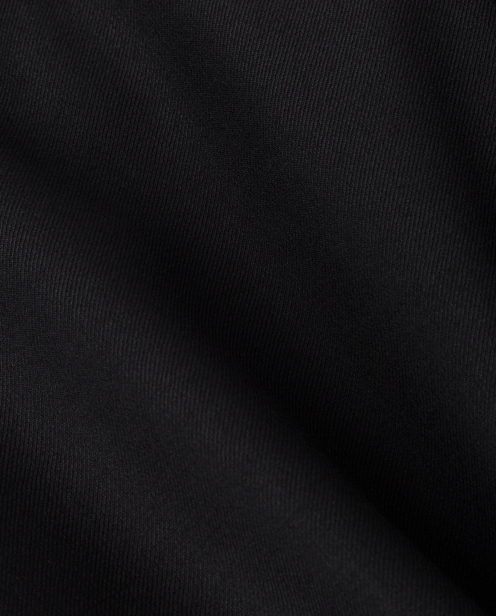 Close-up of the soft black wool-blend twill fabric with subtle diagonal lines, featured on the IVY OAK JUDITH Blazer—ideal for a double-breasted relaxed-fit style.