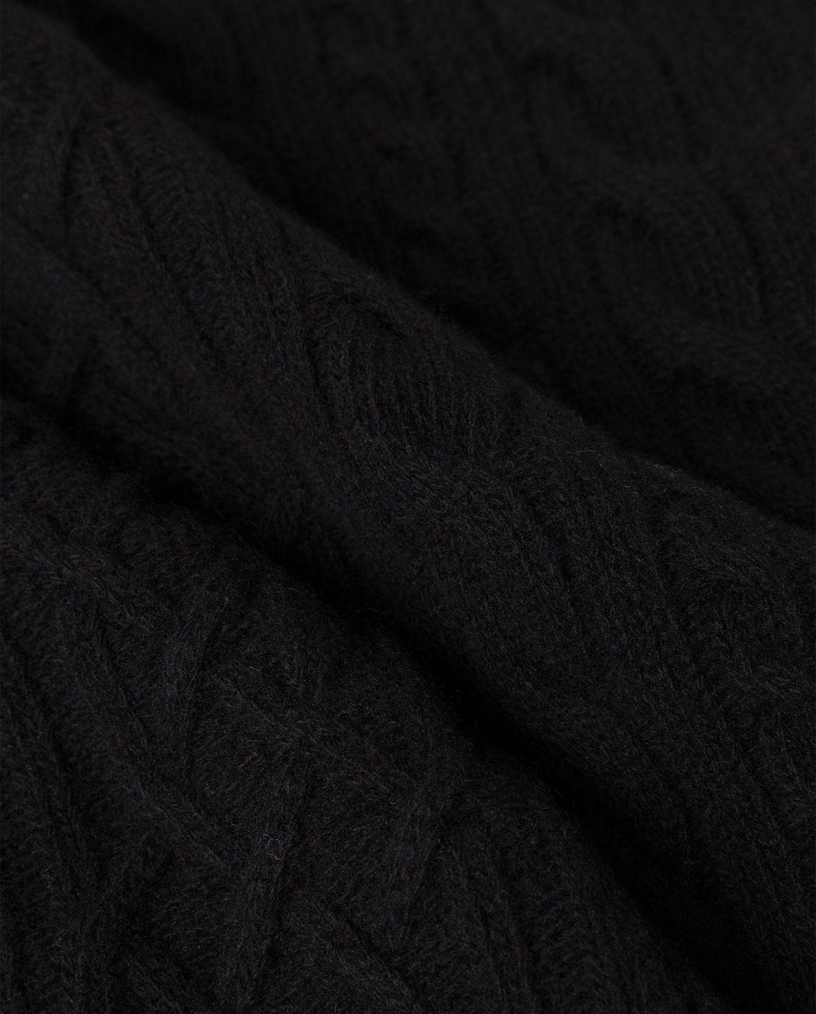 Close-up of the AMELIA Scarf by IVY OAK, crafted from supergeelong extrafine merino wool with a textured cable-knit pattern—ideal for cozy winter days.