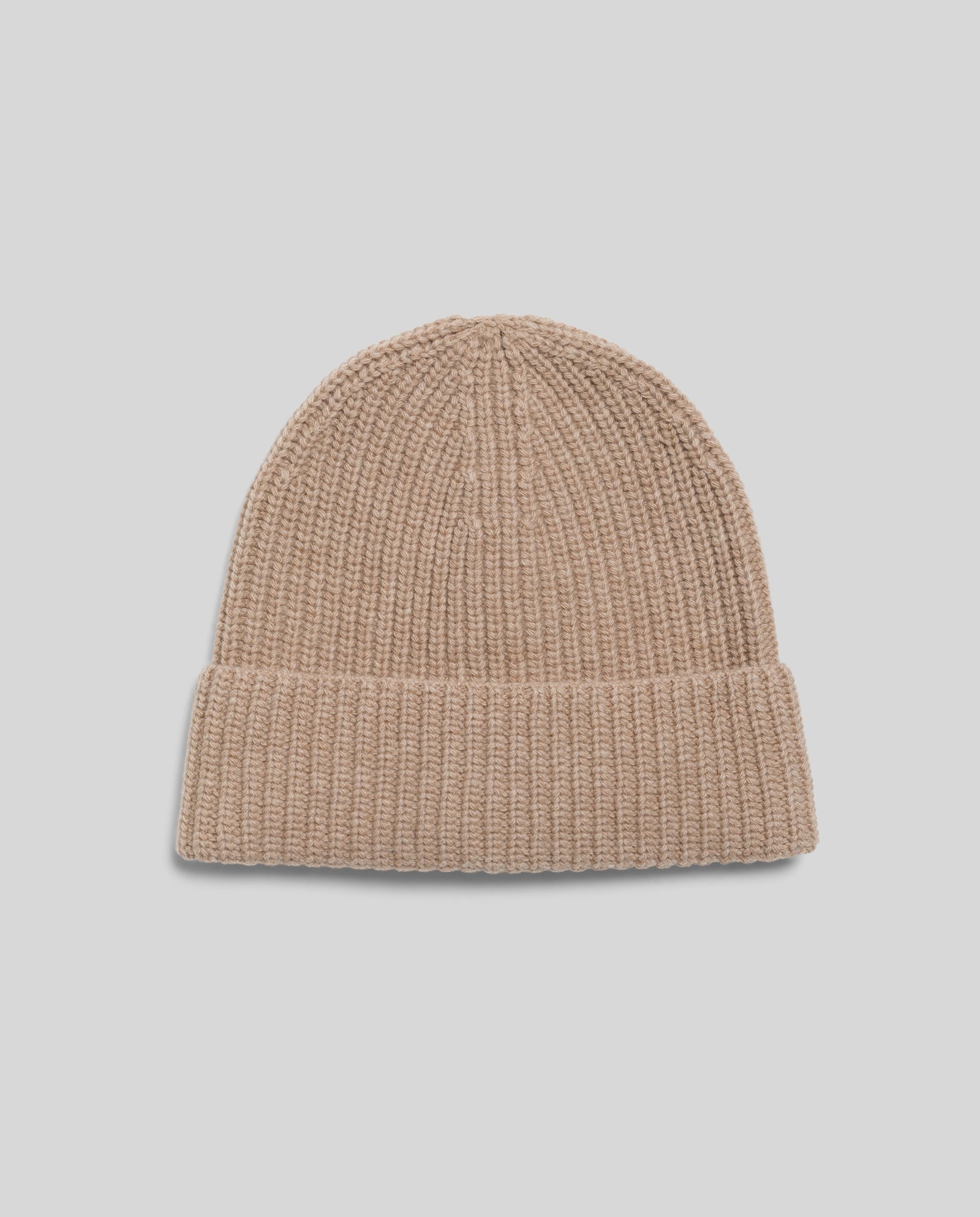 The IVY OAK AMBER Beanie, crafted from soft merino wool with a beige ribbed design and folded brim, is shown against a light gray background.