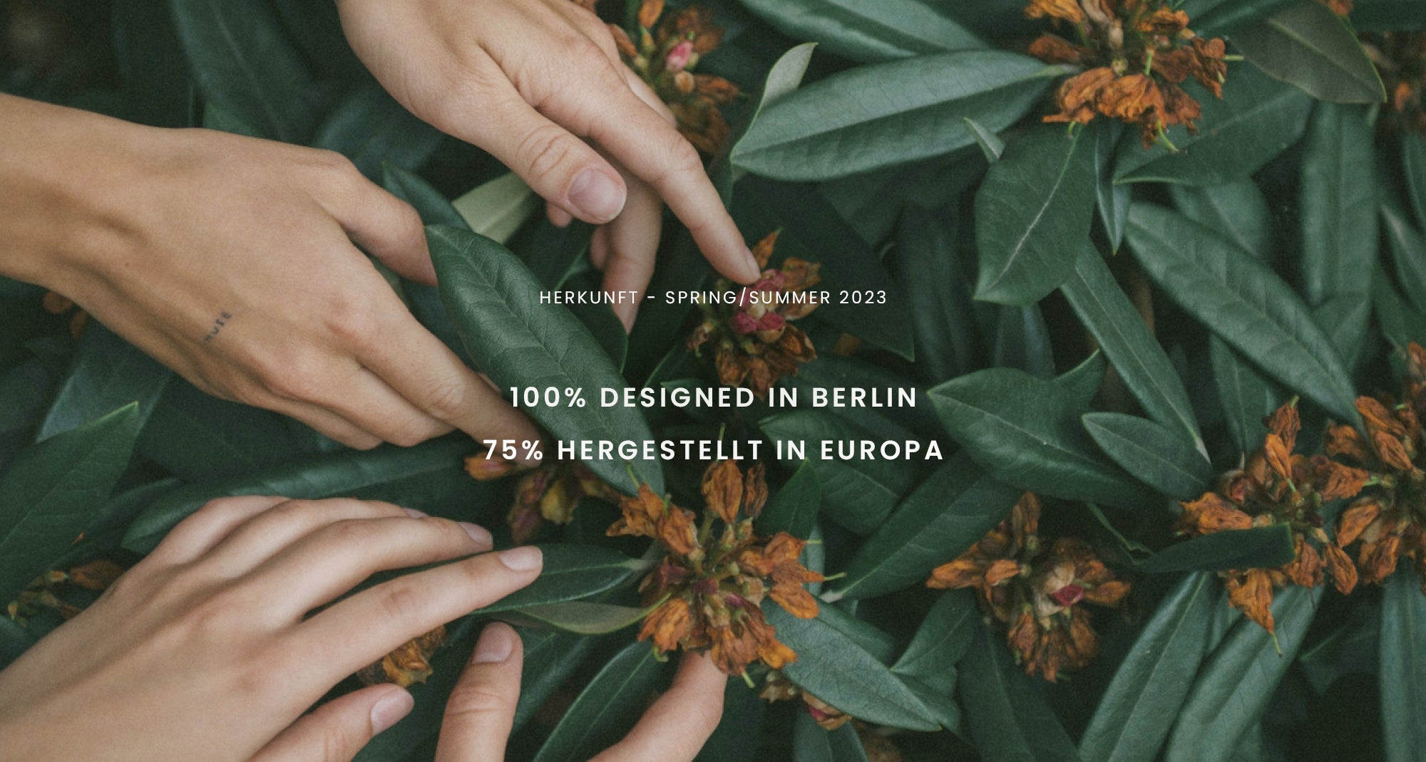 Hands touching green leaves with small orange flowers; overlaid text about design and production in Europe.