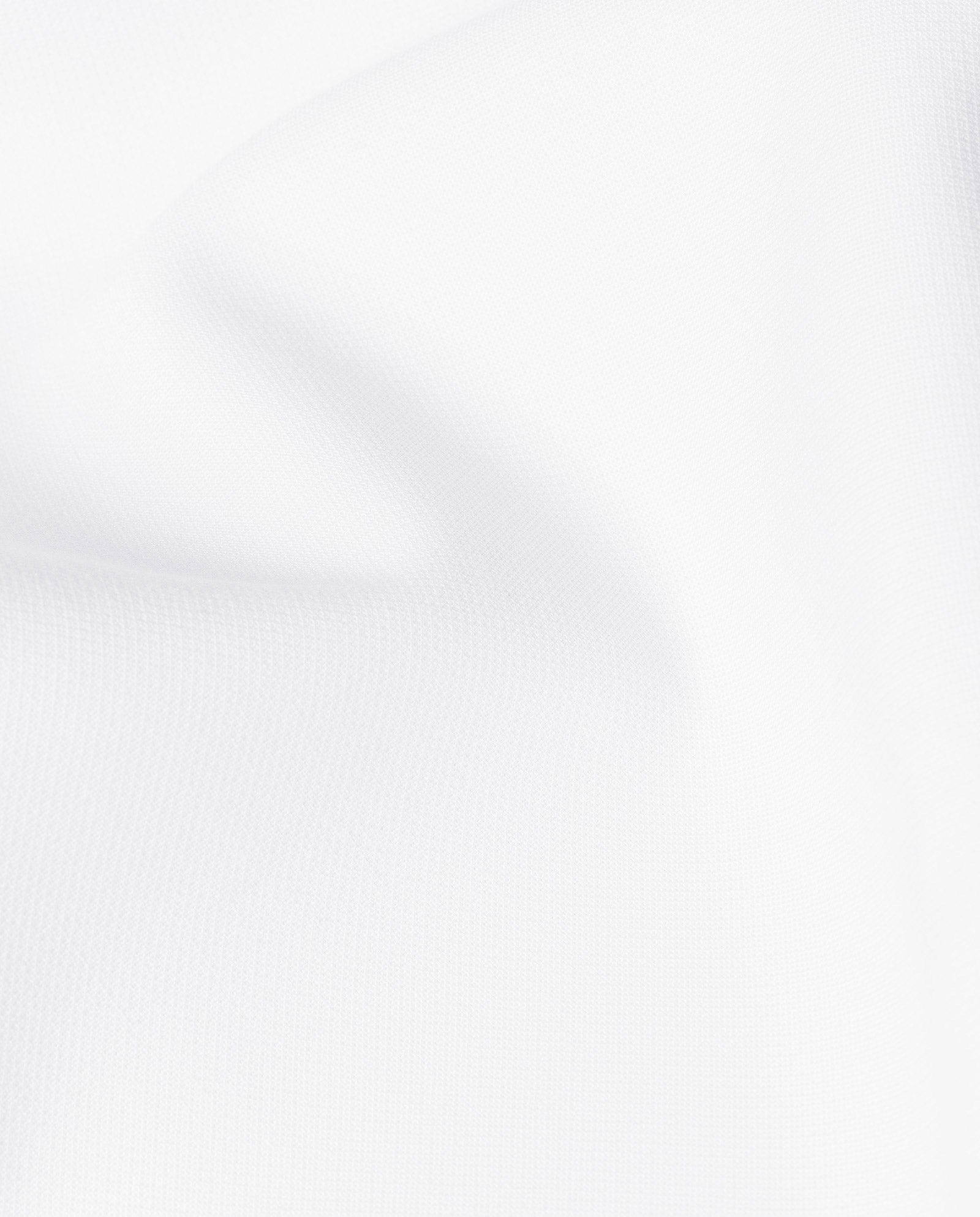 Close-up of smooth, white fabric with gentle folds and soft shadows, ideal for crafting IVY OAKs Ankle Length PIPPA Pants featuring sleek pockets and a subtle zipper.