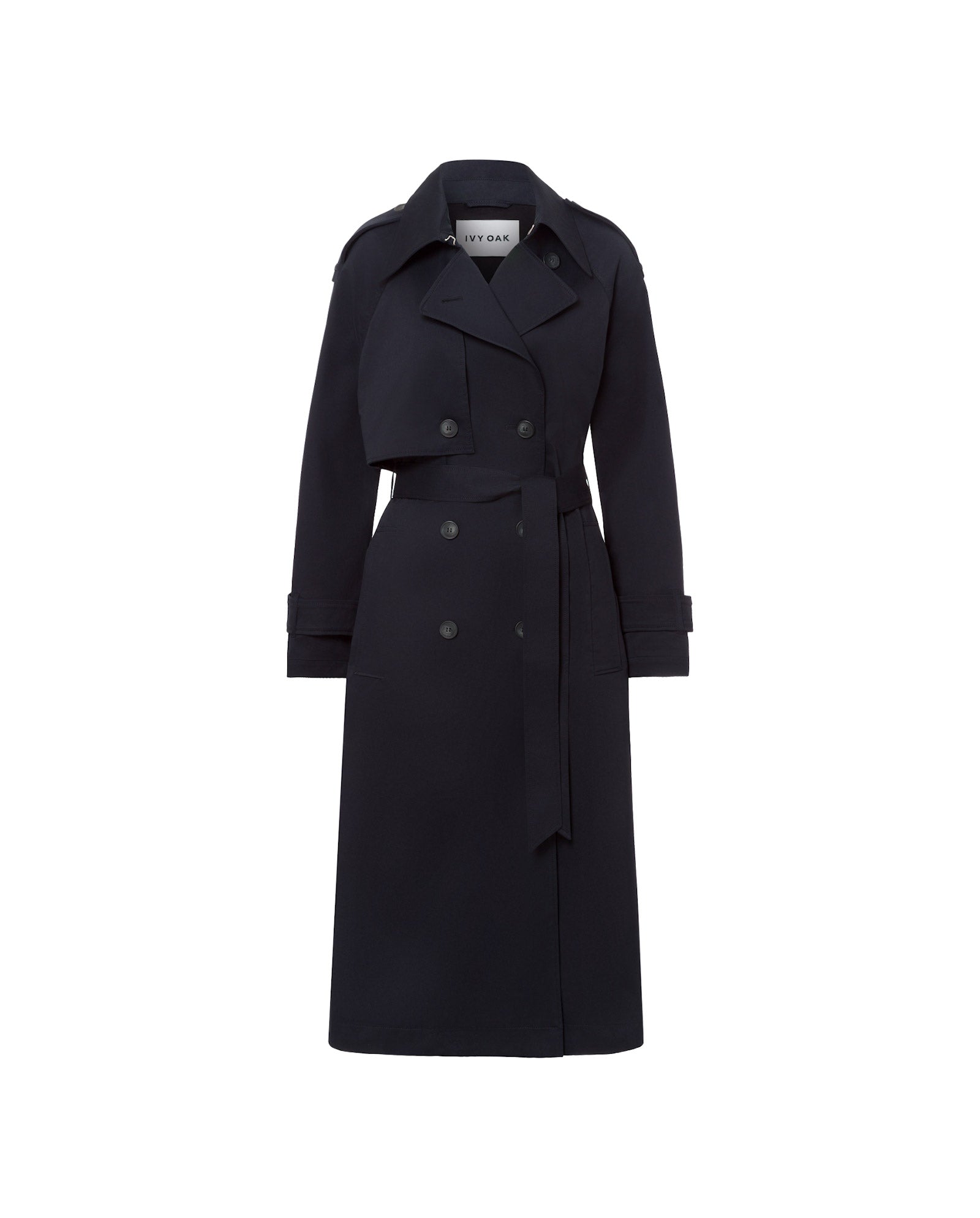 The IVY OAK CORALINE Coat is an oversized, long dark navy double-breasted trenchcoat with a belt and wide lapels, crafted from organic cotton, shown on a white background.