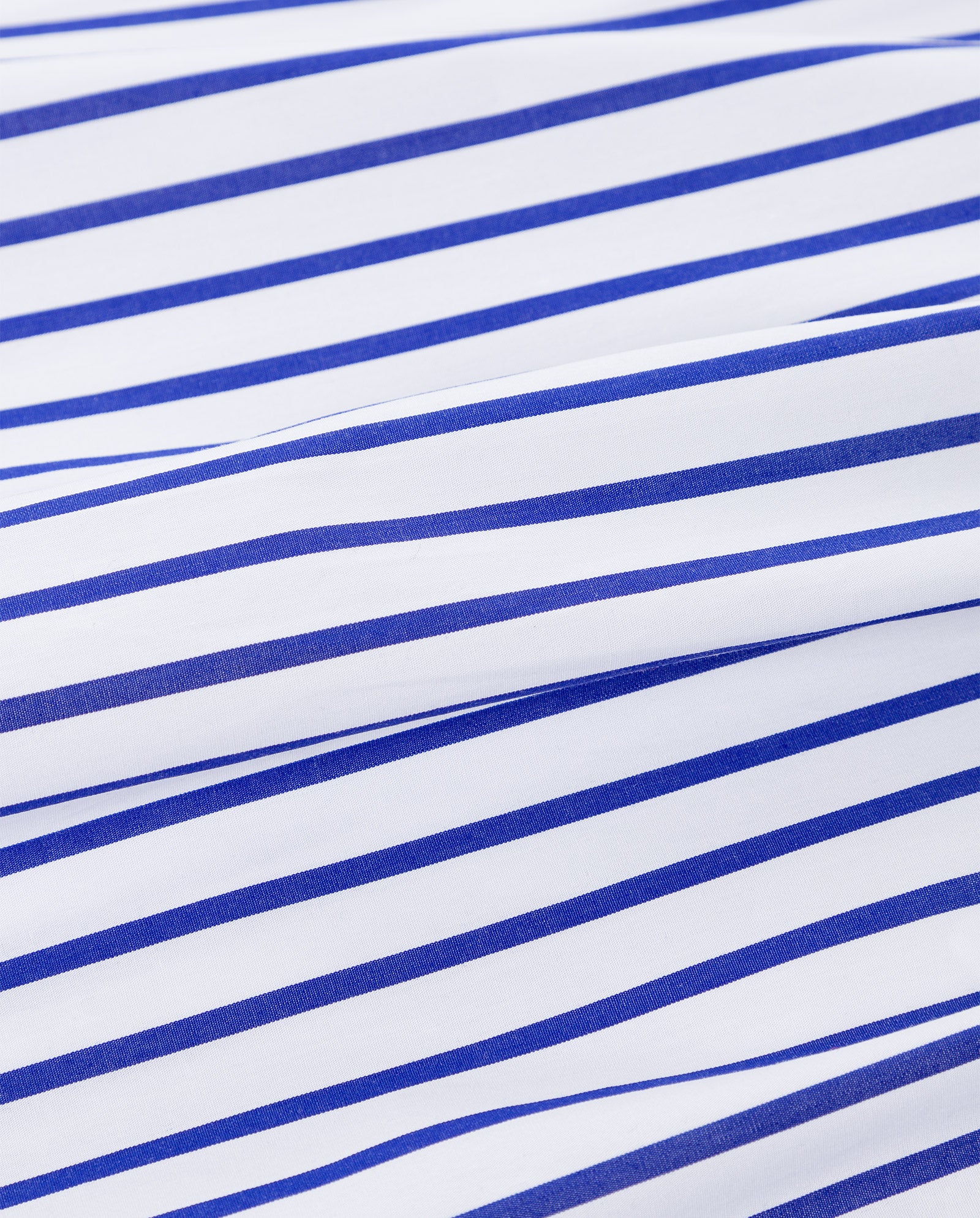 The IVY OAK BETHANY LILLY Blouse features white cotton fabric with evenly spaced blue diagonal stripes, shown slightly wrinkled in the center.