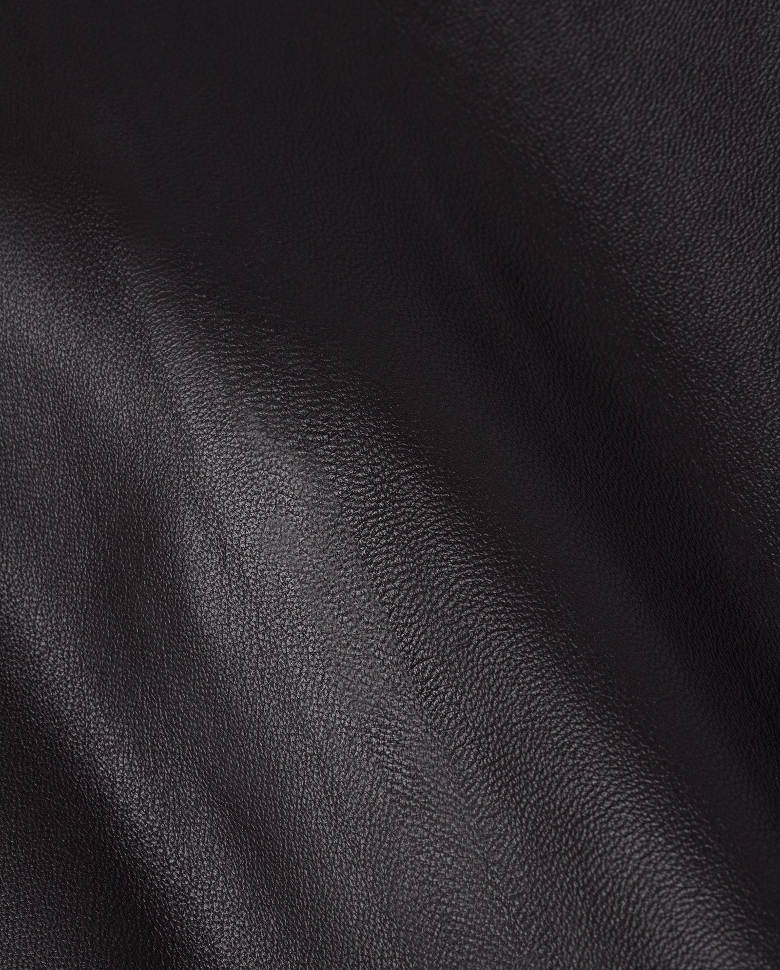 Close-up of the IVY OAK LAUREEN Leather Skirt in black, showcasing its chrome-free tanned leather with soft natural wrinkles and a smooth, slightly shiny surface.