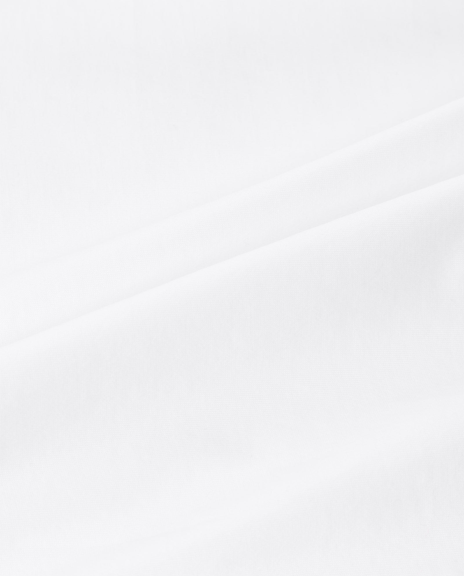Smooth white organic cotton with soft, gentle folds forms subtle diagonal lines—a wardrobe essential. Perfect for the KYLA T-Shirt by IVY OAK.