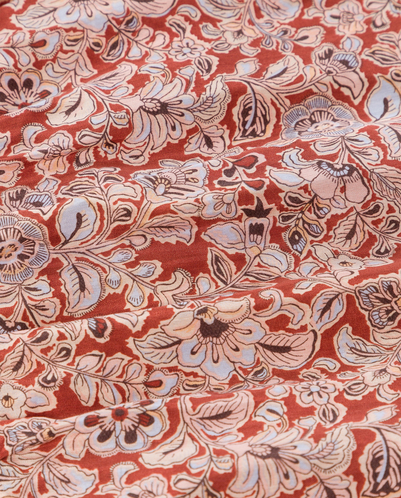 The IVY OAK ENRICA Blouse features red fabric with cream and light blue floral patterns, a V-neckline, elegant balloon sleeves, and a cropped fit.