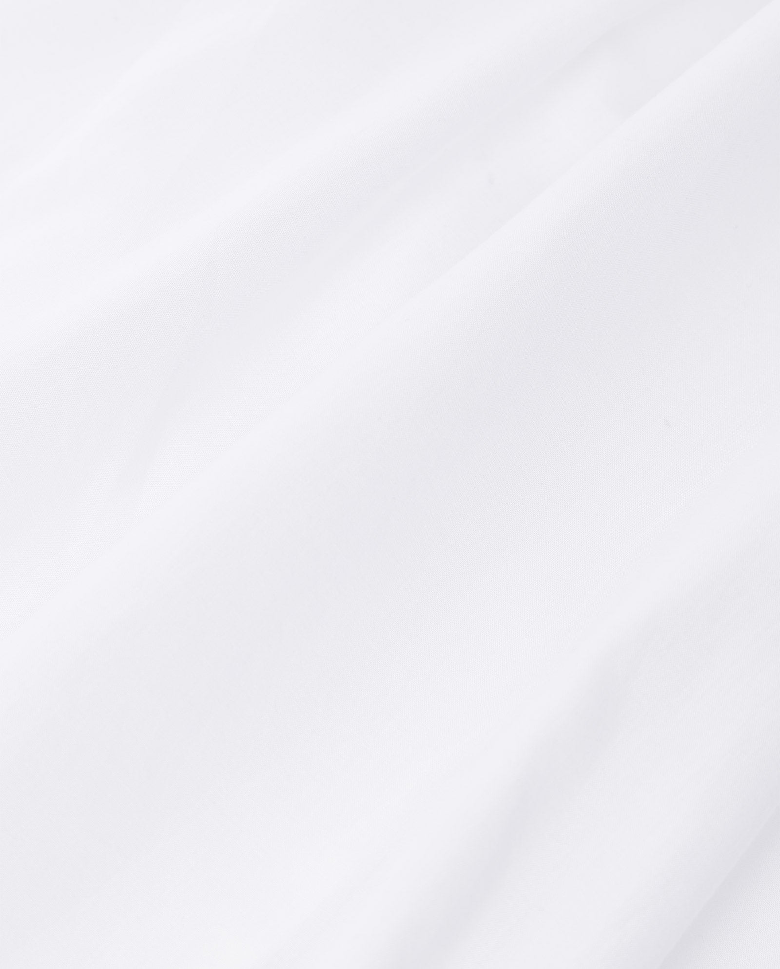 Close-up of smooth, white cotton voile fabric with soft folds and gentle shadows, ideal for delicate lace tape or crafting the elegant IVY OAK EVELINA Blouse.