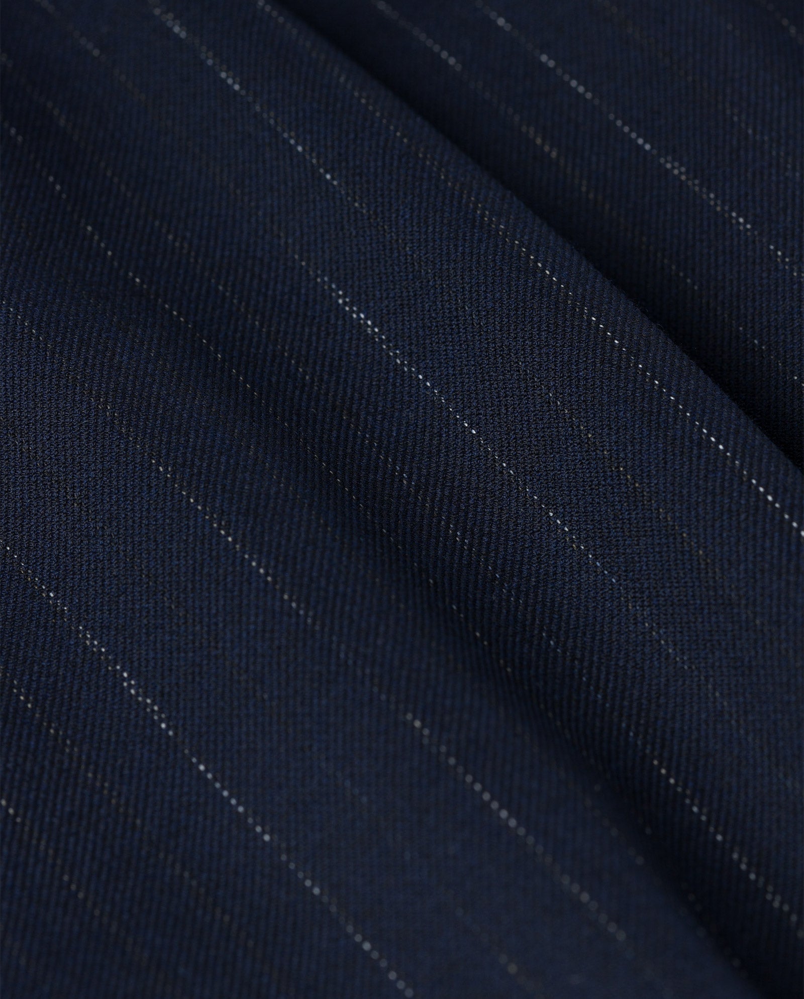 Close-up of the PHOEBE ANN Trouser by IVY OAK, featuring navy blue pinstripe fabric with thin light stripes and a subtly textured surface—perfect for high waist pinstripe pants.