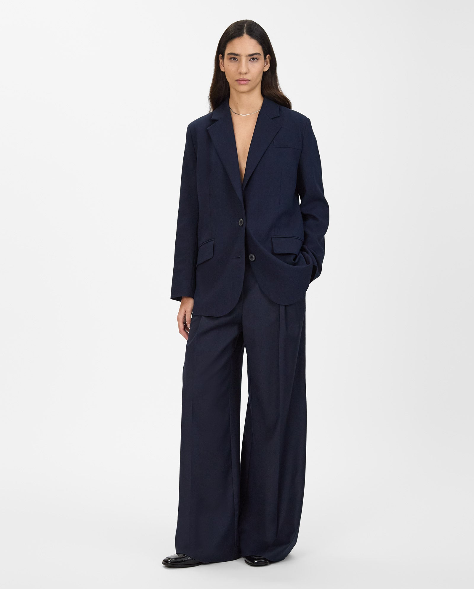 A woman models the IVY OAK JUNA Blazer with matching wide-leg trousers, standing against a plain white background.
