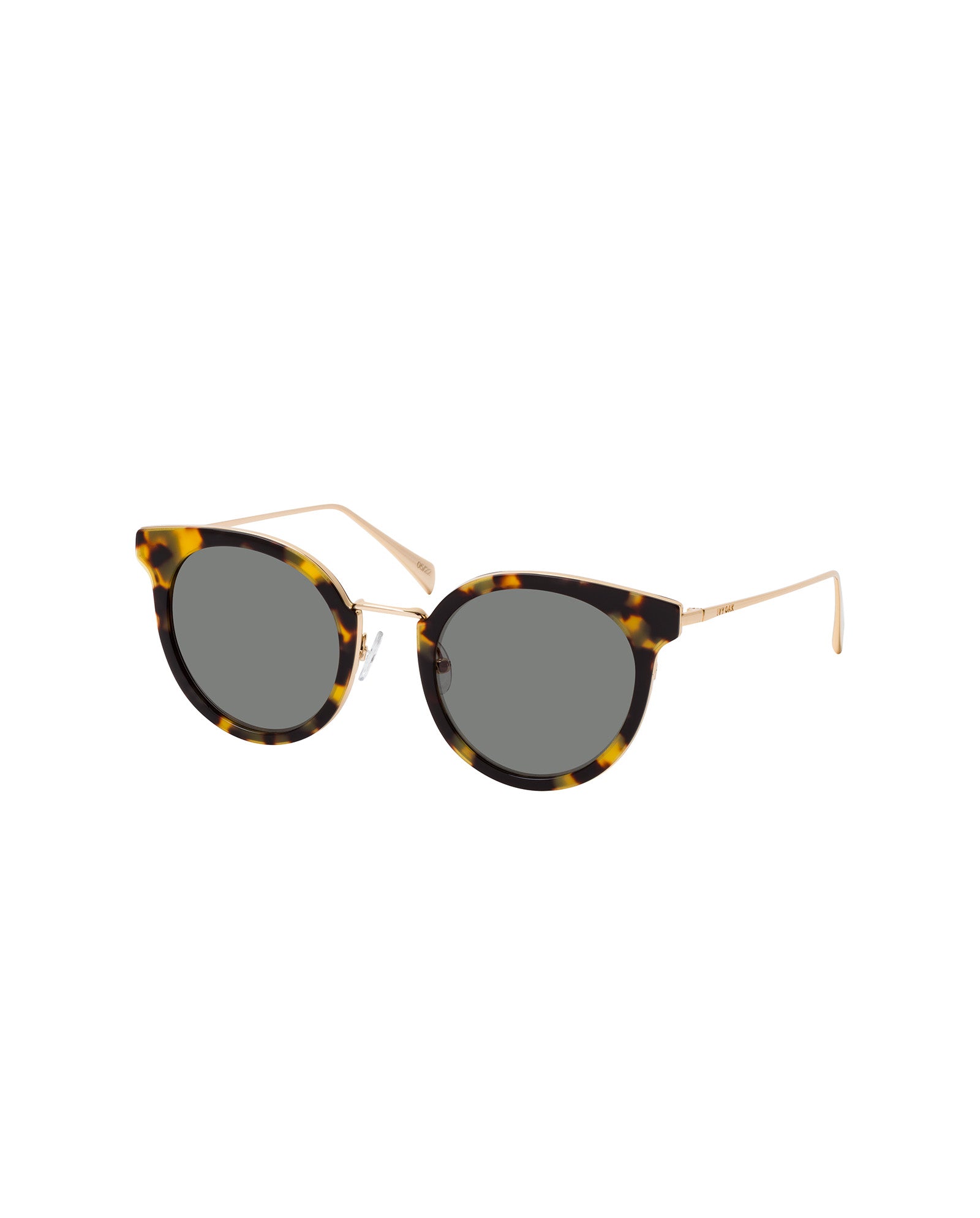 The IVY OAK Abigail Sunglasses feature round tortoiseshell frames, gold metal arms, and dark lenses. Made from bio-based materials, they are shown on a white background.