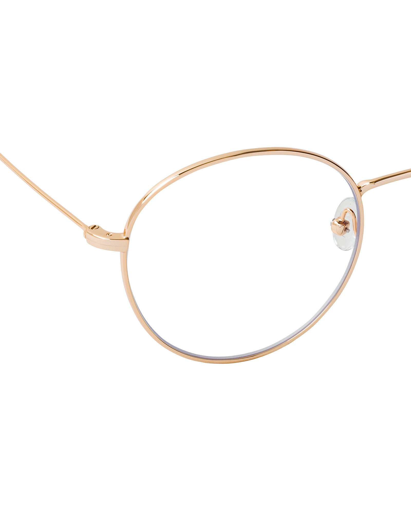 The IVY OAK Aileen Glasses feature a gold-rimmed, round, thin metal frame with clear lenses, crafted partly from recycled materials and shown from the side.