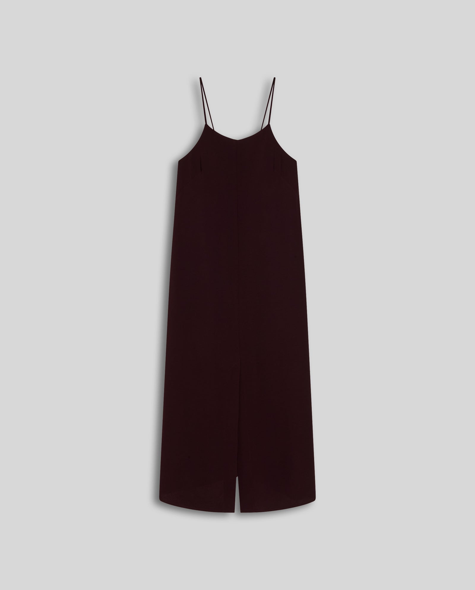 The NAVA Dress by IVY OAK is a sleeveless black crepe slip dress with thin spaghetti straps and a front slit—perfect for summer—shown against a plain light gray background.