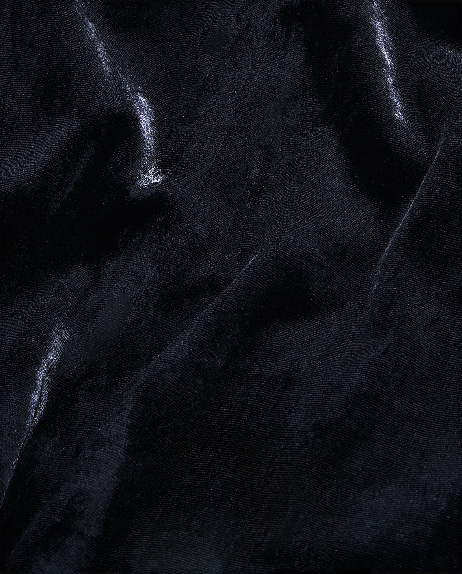 The NESTA ROSE Dress by IVY OAK features shiny black velvet with soft folds and a smooth, light-reflecting surface, perfect for a chic midi look with an elegant zipper closure.